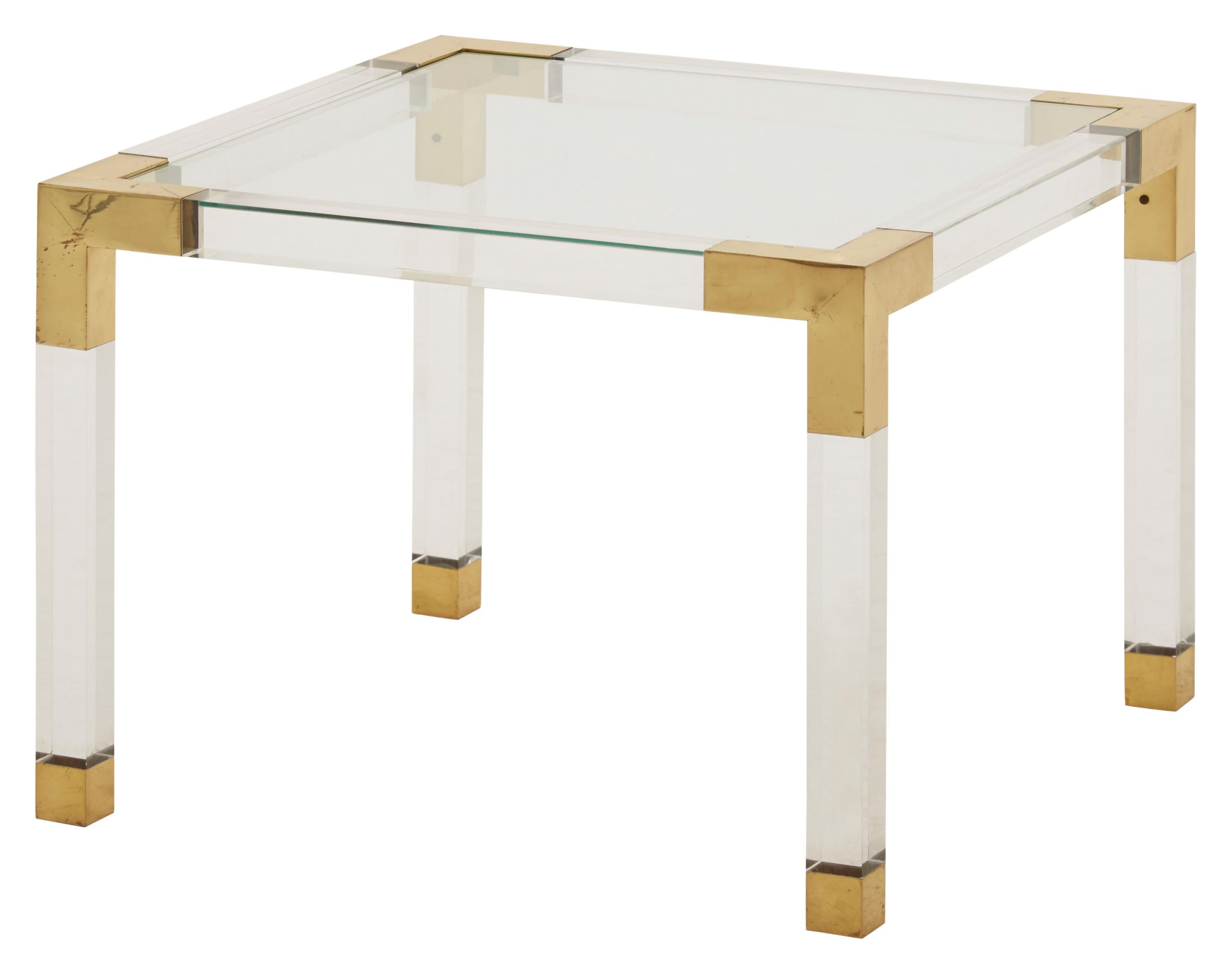 • Lucite with patinaed brass details
• Glass top
• Mid-20th century
• France
• Measures 23.75