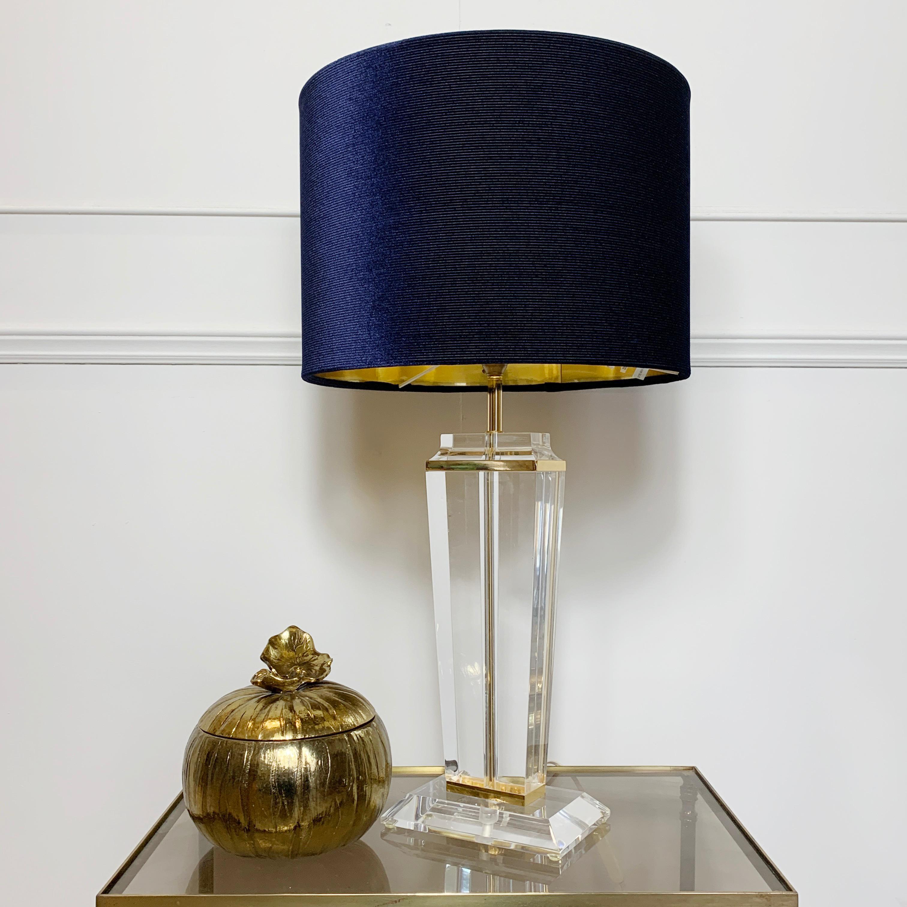 French midcentury Lucite table lamp
circa 1960s-1970s
Lucite lamp base with gilt details 
Measures: 68cm height (inc shade) lamp base 47cm height, shade 36 W x 26 H, base 18cm x 12cm

There is a rocker switch on the cable. The light is wired