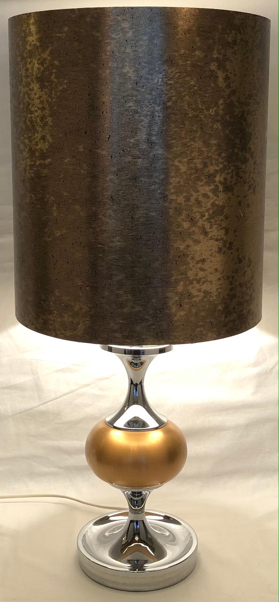 Stylish chrome table lamp designed in the spirit of Maison Jansen. Lamp features a gold shade to complement. Maison Jansen was a Paris-based interior decoration office founded in 1880 by Dutch-born Jean-Henri Jansen. 

This lamp lends itself to any