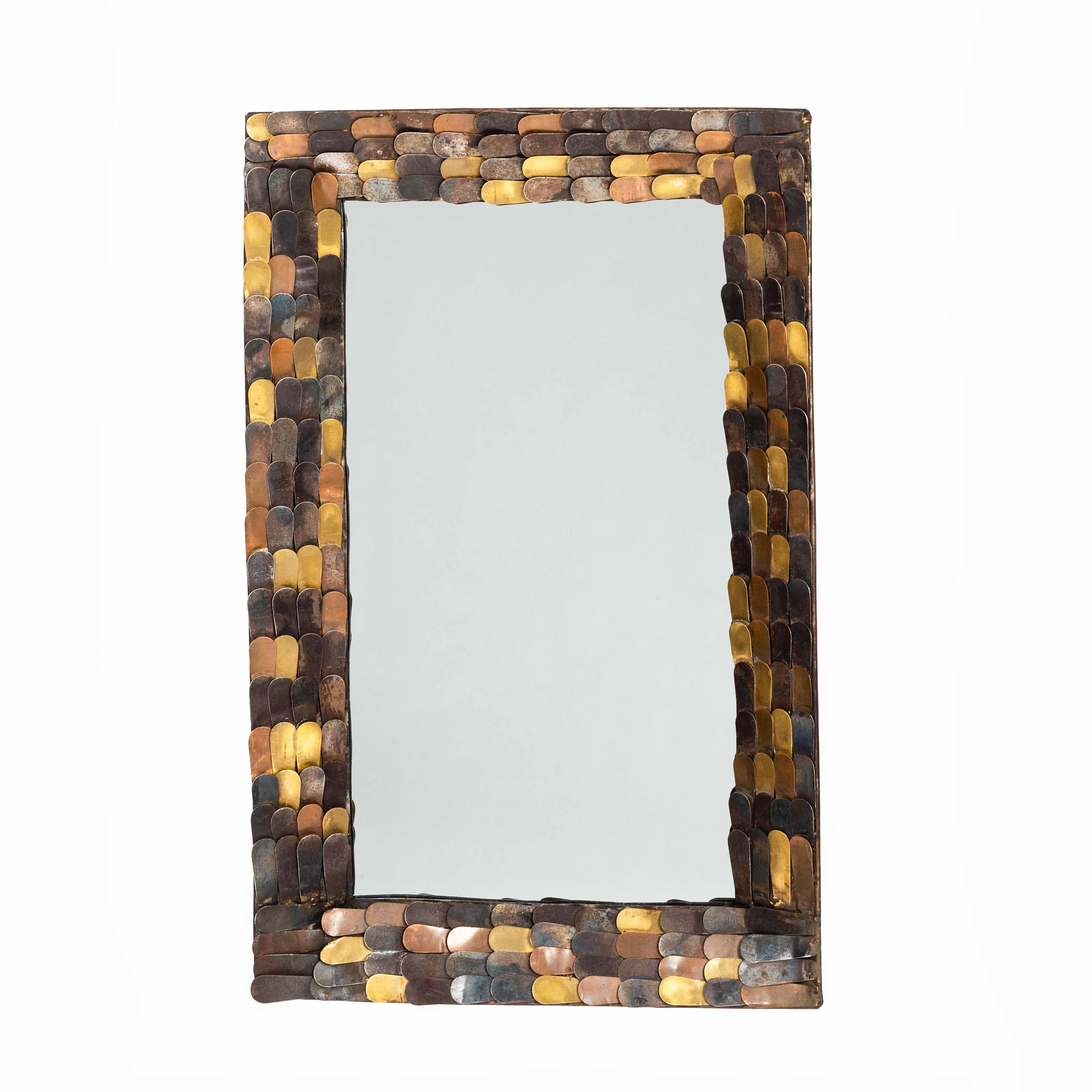 Exceptional mid-century mirror with metal scales of copper, brass and iron, Fance 1960-ies.

The frame has a width of 8.0cm and is beveled inward.  The tapered scales of the different metals are arranged in one direction and do not follow any