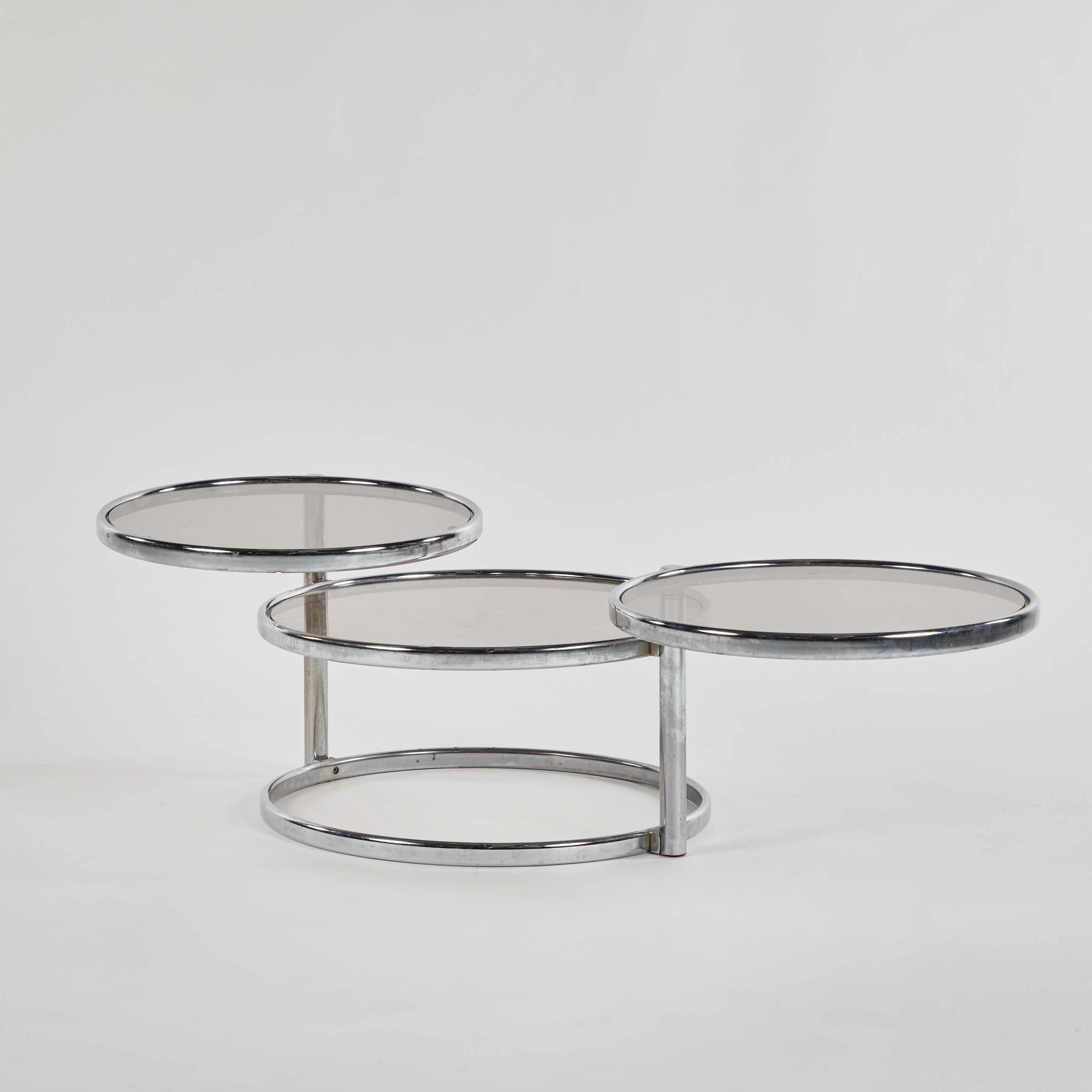 French Mid-Century Modern 1960s round glass top extending table. The different table surfaces rotate to extend outwards. 