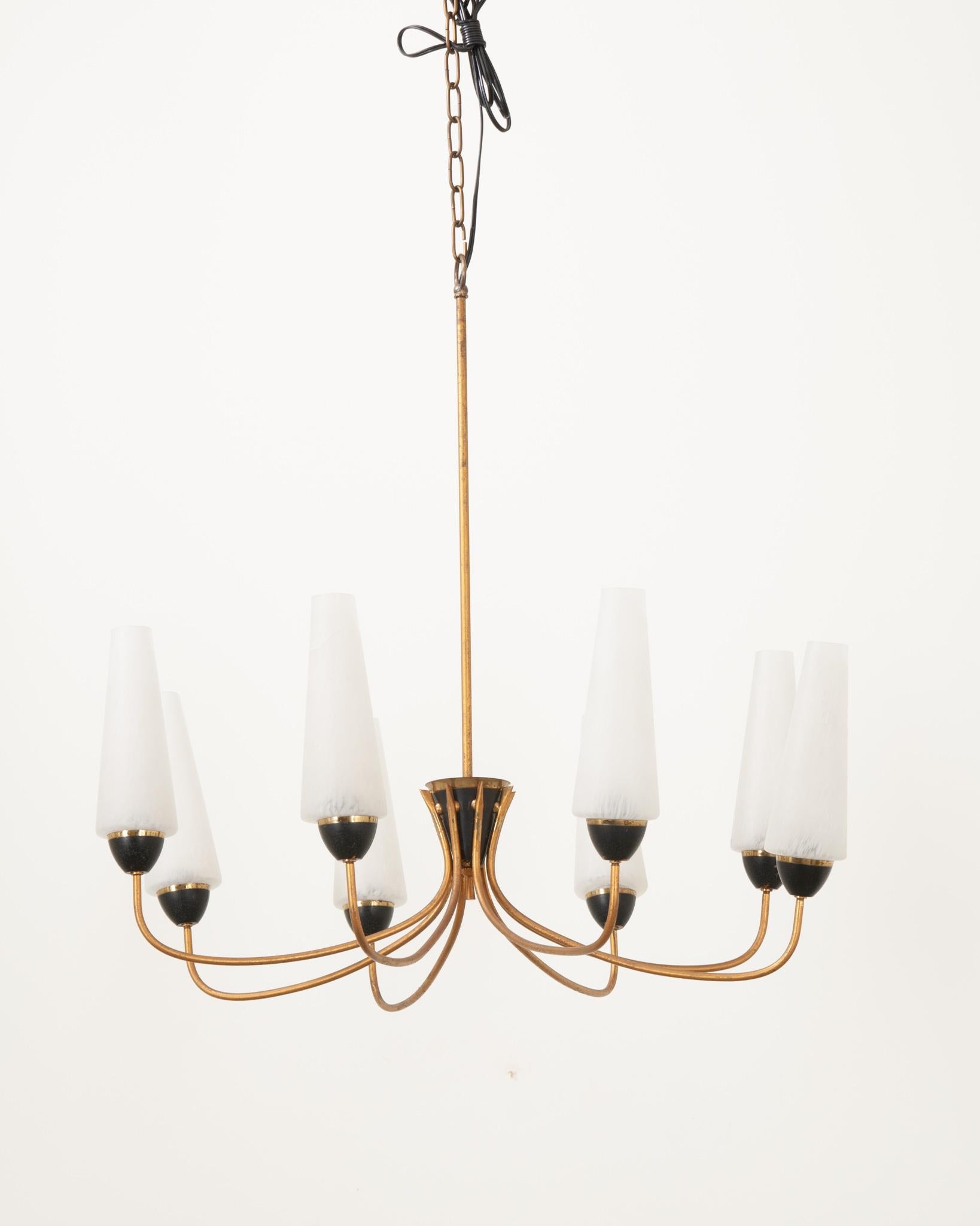 A classic mid-century 8 light chandelier. The chandelier frame is made of a gold painted metal with ebony metal accents and removable frosted glass cone shades. Above the rod we have 32” of chain with 8 feet of excess wire and a 5” diameter canopy.