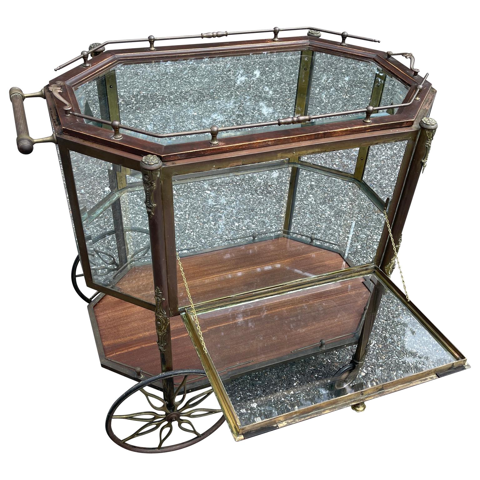 Mid-Century Modern dessert or pastry cart, France circa 1940-1950's.
Just feast your eyes on this beauty. The wooden and brass pastry or bar trolley stands proudly on it's original front caster wheels accented by large trolley back wheels with