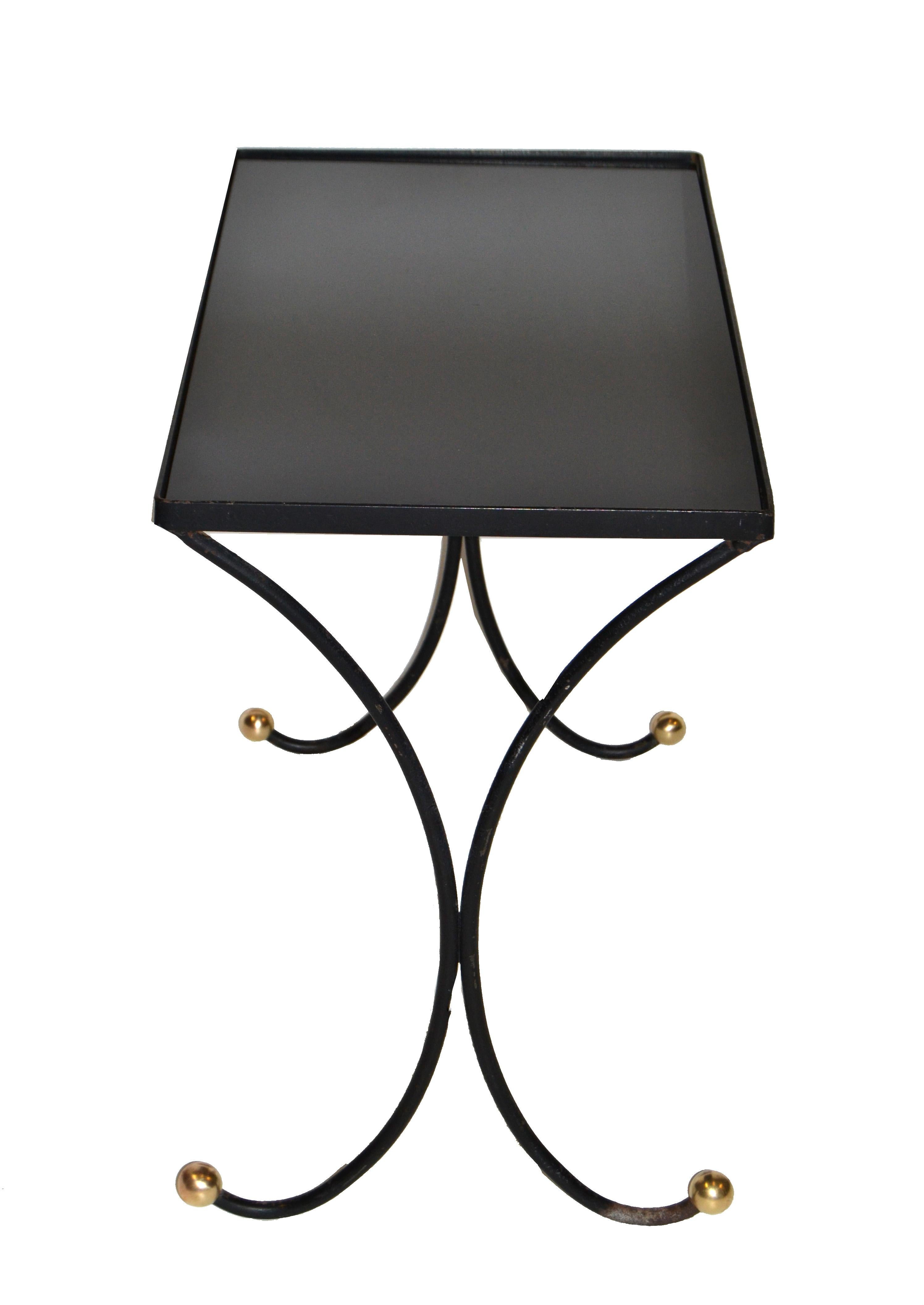 We offer this original 1950s ebonized wrought metal side table with round brass feet.
features a black glass top.
Is left in original condition with wear to the feet.