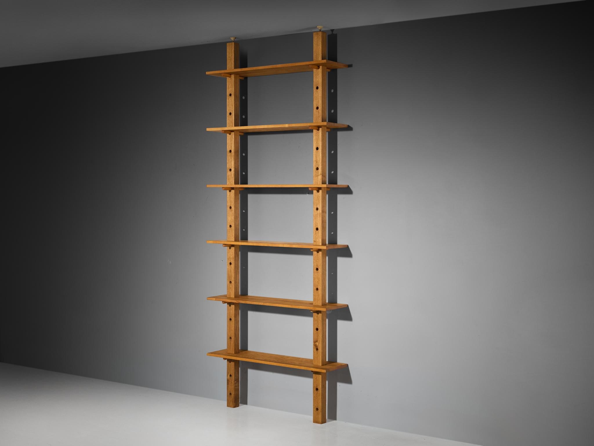 Bookcase / wall shelving unit / room divider, solid ash, France, 1960s 

This mid-century modern French bookcase, dating from the 1960s, balances functionality with structural minimalism. Crafted from ash, its warm, honey-hued timber breathes a