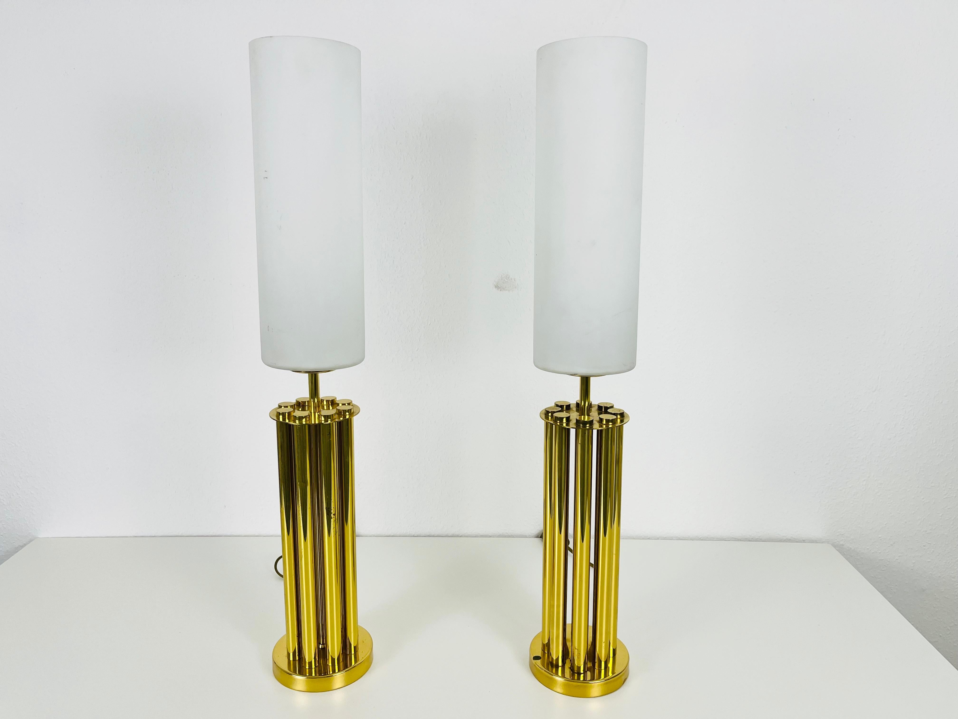 A beautiful pair of midcentury table lamps made in France in the 1960s. It is fascinating with its beautiful pillar shape. The table lamps are made of polished brass and opaline glass.

Measurements:

Base diameter 12 cm

Height 74 cm

Good