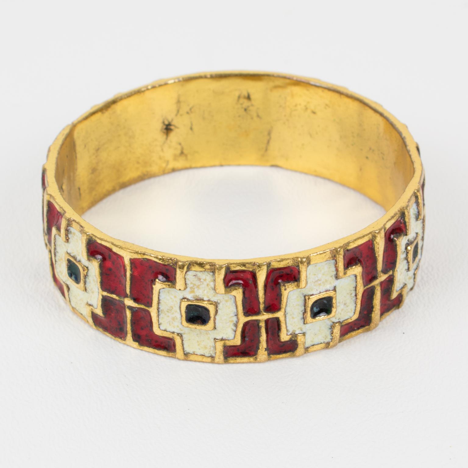 This lovely modernist bronze bracelet bangle was made in France in the 1960s. 
A large gilt bronze band topped with a geometric design ornate with red, white, and black-green enameling. There is no visible maker's mark.
Measurements: Inside across