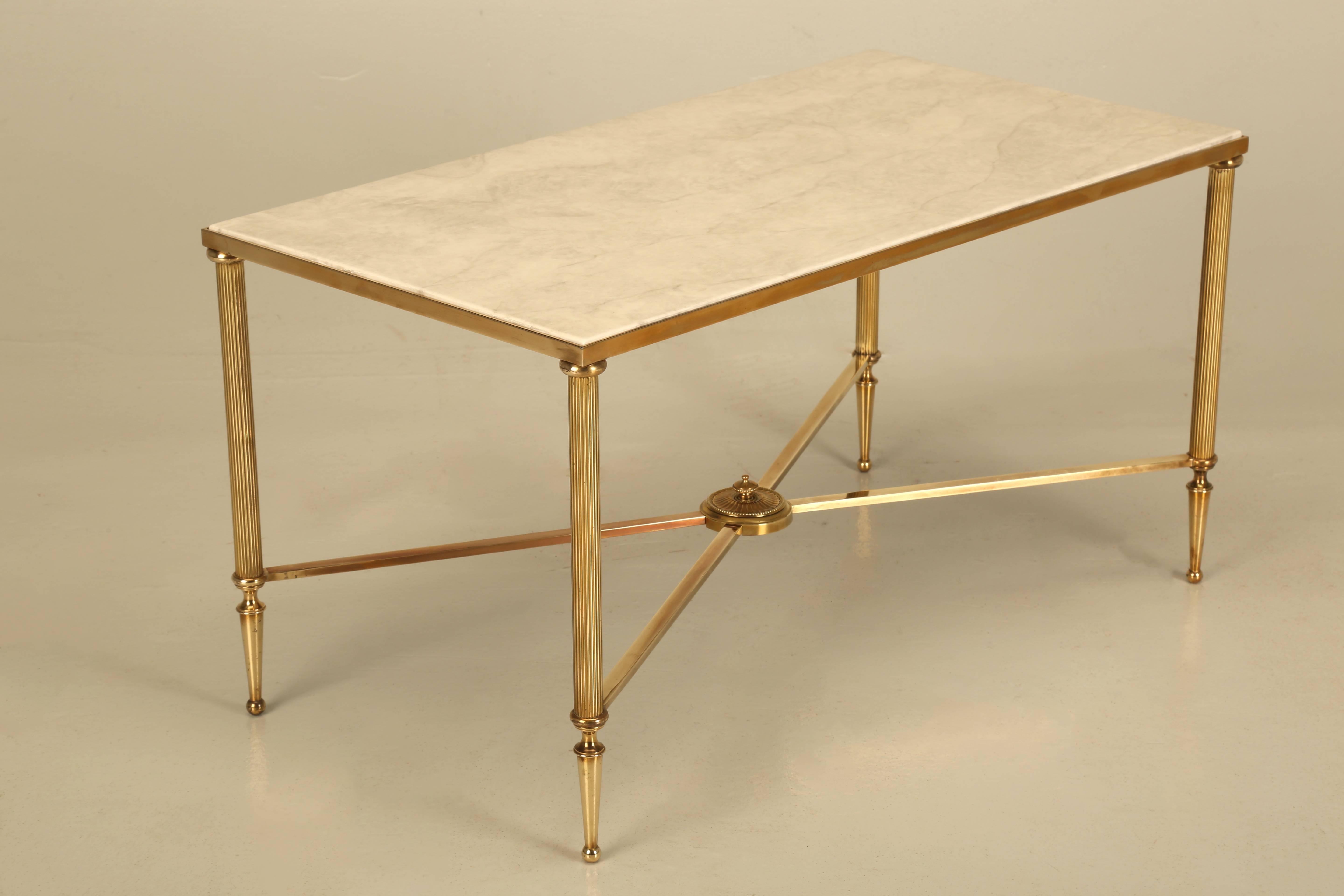 Vintage French, Mid-Century Modern coffee or cocktail table. Generally, there petite coffee tables have just a brass plated frame, but whomever made this one, built the Mid-Century Modern coffee table from polished solid brass and no, it is not