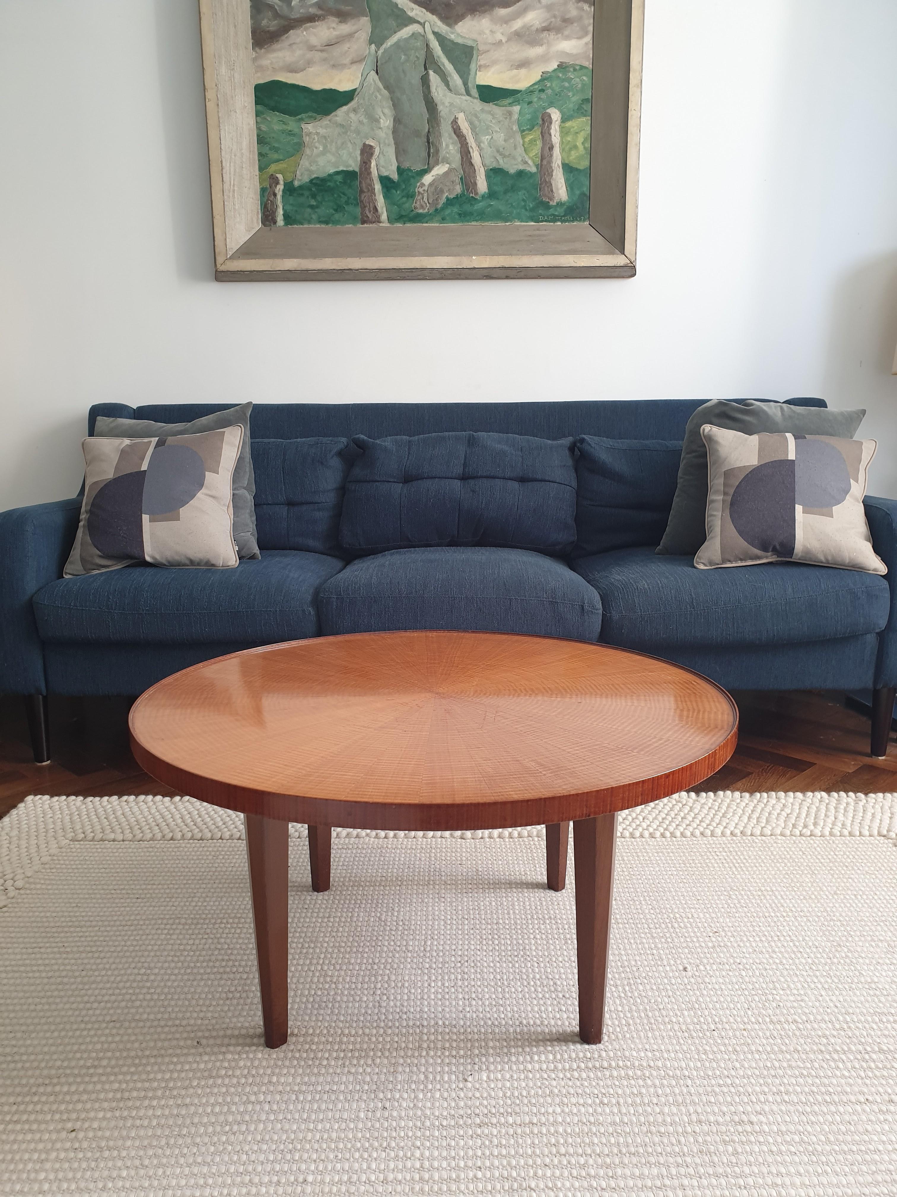 Coffee table in fiddled sycamore with sunburst designed veneer to the top and legs cut in a pentagon shape.