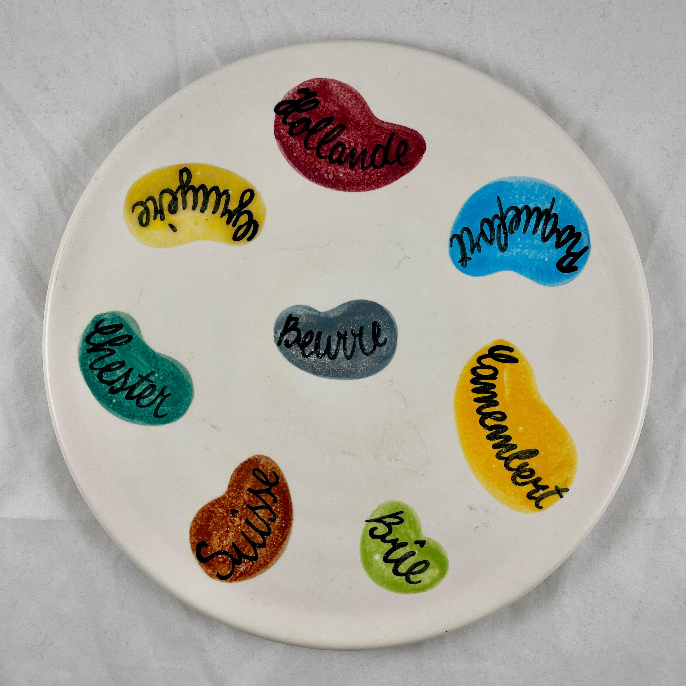 A French mid-century era ceramic cheese charcuterie platter manufactured by Ceramiques Elchinger, circa 1960s.

The tray is hand-painted with the names of popular cheeses on a matte finish creamy white ground. The selections include Roquefort,