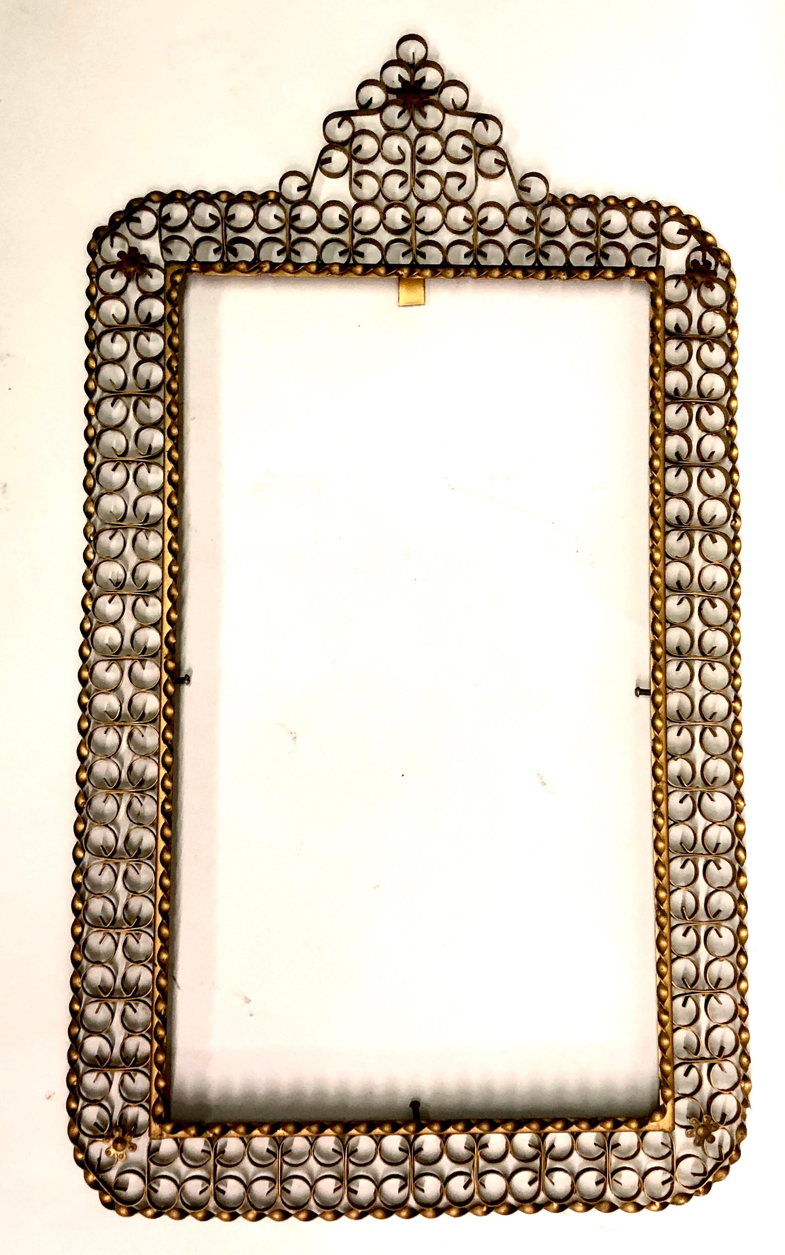 Elegant and Timeless French mid-century, modern neoclassical, gilt wrought iron, Filagree mirror by Maison Jansen.
