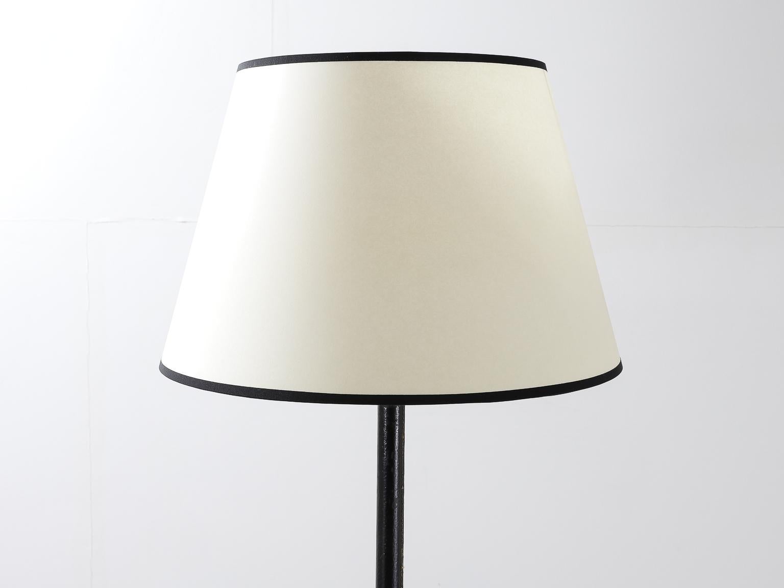 French Mid-Century Modern handstitched leather and brass floor lamp attributed to Jacques Adnet.