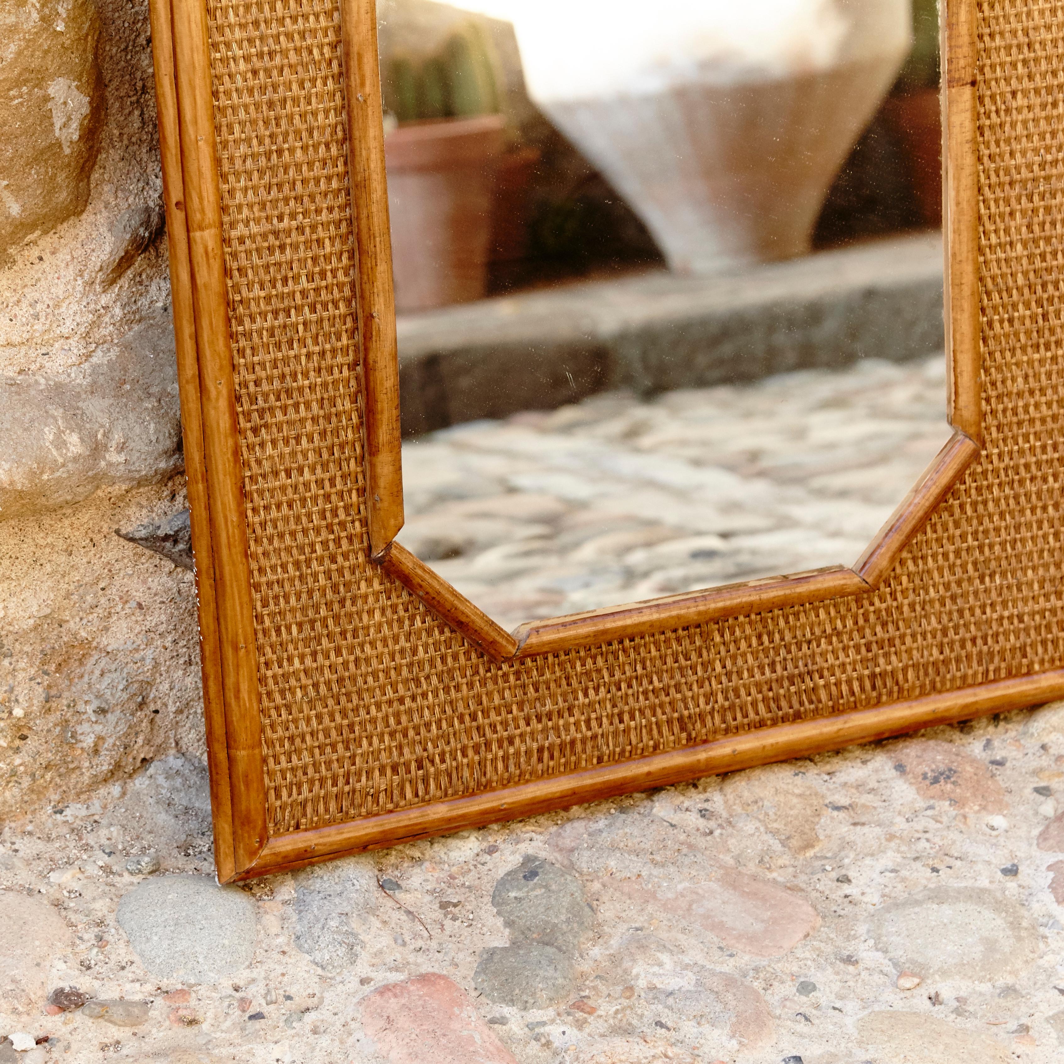 Handcrafted mirror made in French, circa 1960
Bamboo and rattan.

In original condition, with minor wear consistent of age and use, preserving a beautiful patina.