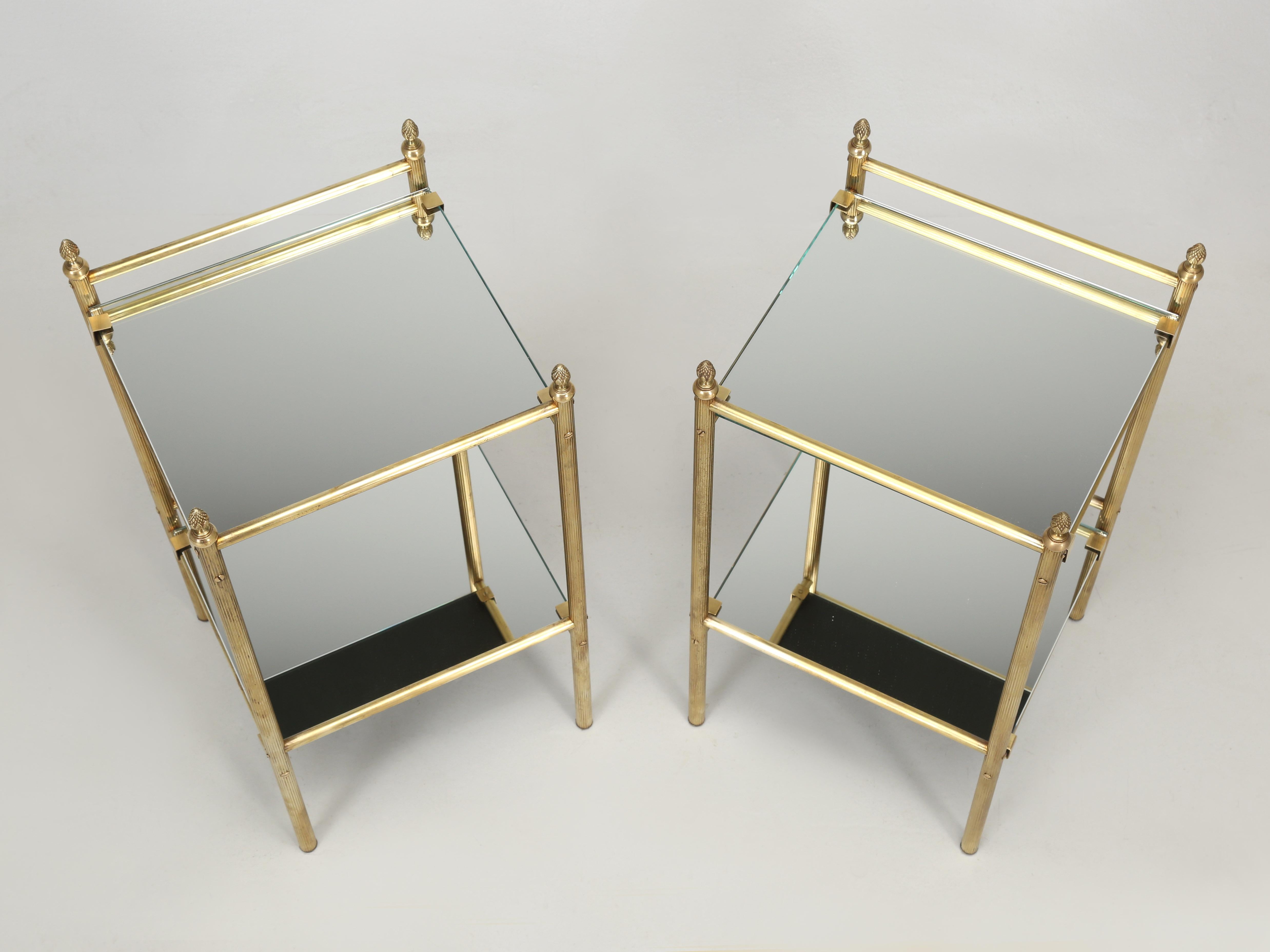 French Mid-Century Modern Pair of Brass End Tables or Side Tables with Mirrored Top Surfaces. We would venture a guess and say these were probably made in the 1960’s and are most certainly from France. The Mirror Tops for the Brass End Tables are