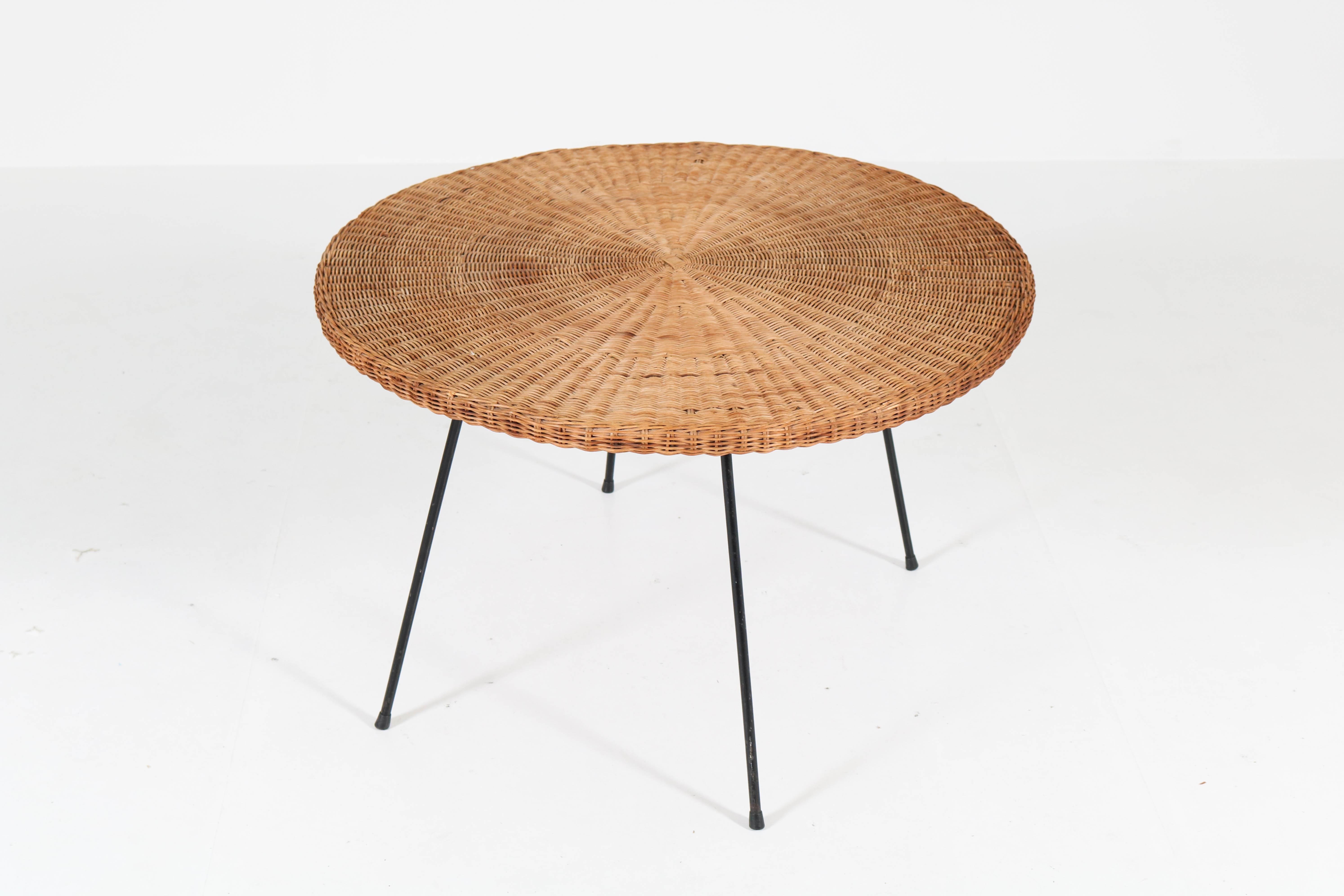 Offered by Amsterdam Modernism:
Stunning French Mid-Century Modern coffee table, 1950s.
In the style of Mathieu Matégot.
Original black lacquered metal legs with original wicker top.
In very good condition with minor wear consistent with age and