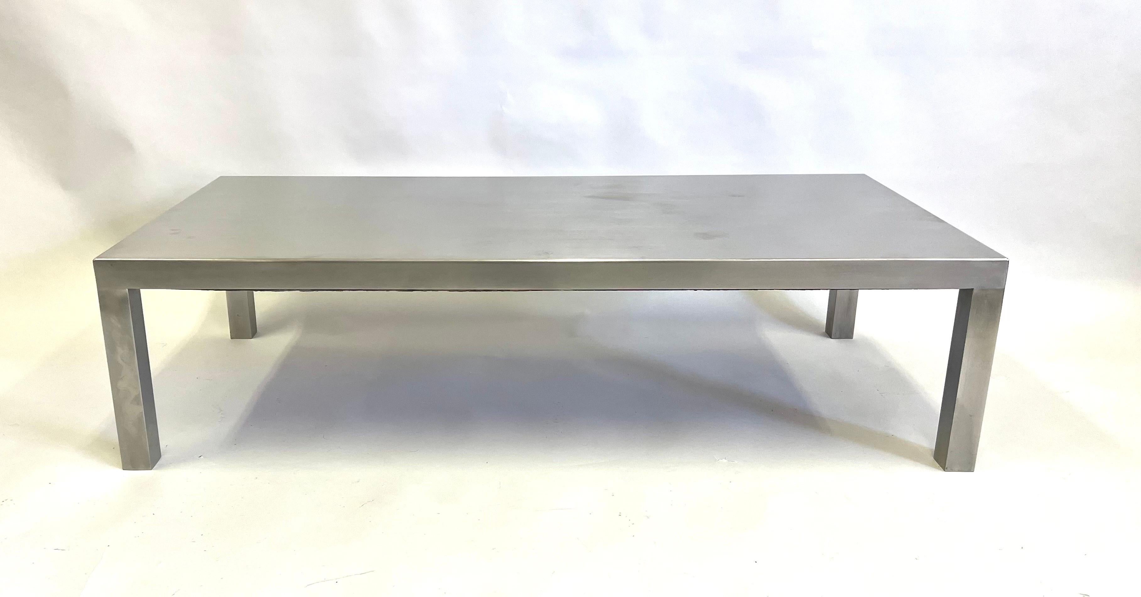 Elegant, sober, minimalist coffee table by Maria Pergay. This piece in matte polished stainless steel covering a black wood frame and is known as Table Droite. The piece was made for Maison et Jardin, Paris, 1971.

Maria Pergay was one of the