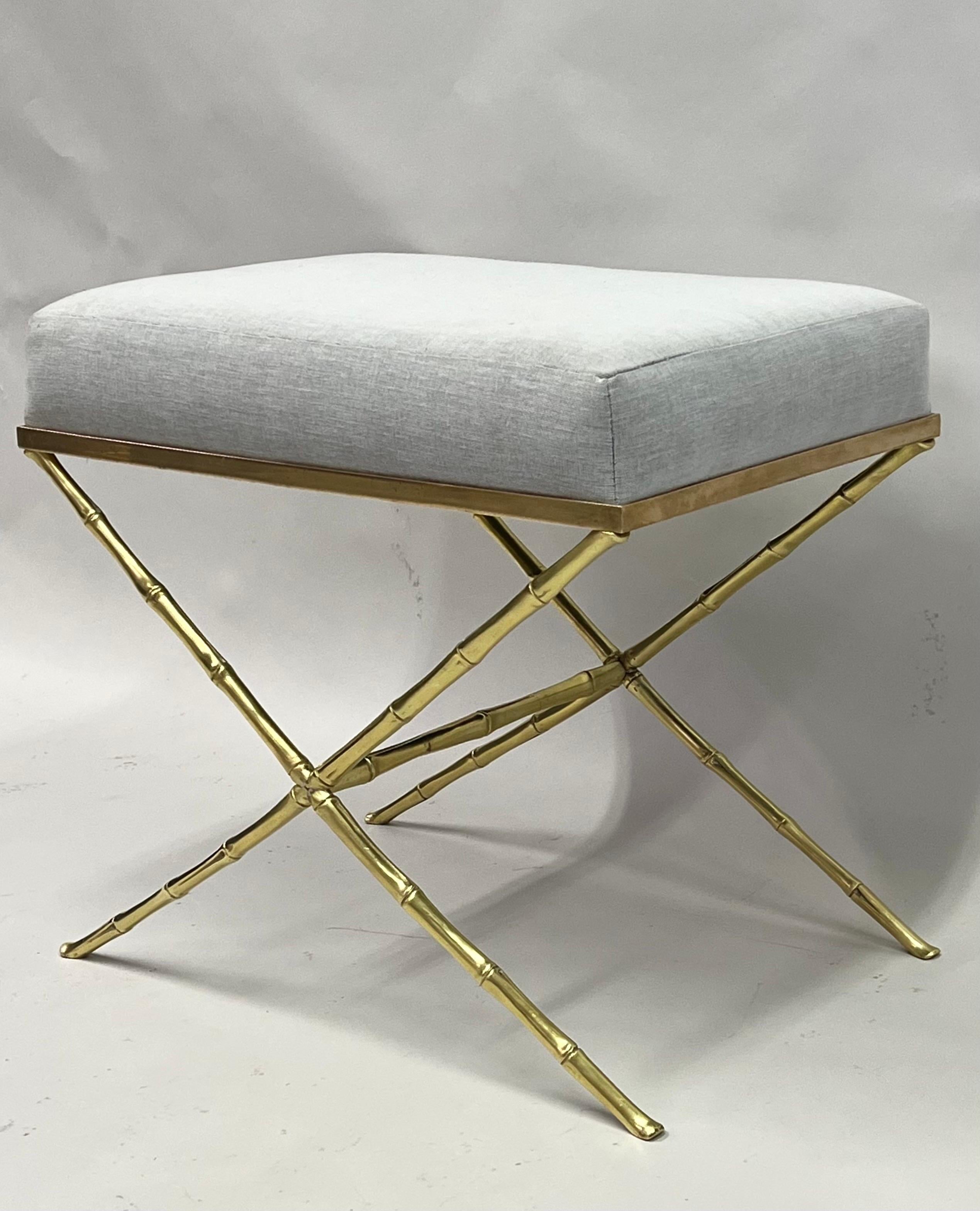 An elegant and timeless French Mid-Century Modern neoclassical bench or stool by Maison Baguès in solid brass. The piece has pure lines with a classical X-frame or Curile form base structure and is composed of brass faux bamboo. Simplicity and