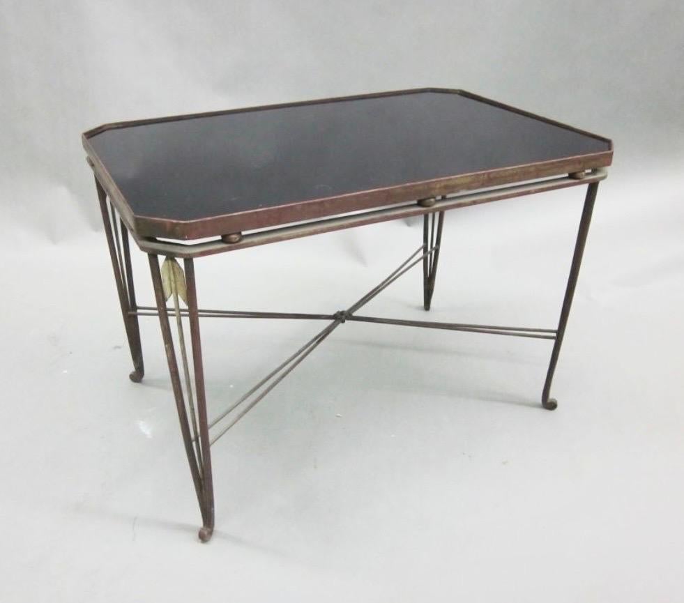 Elegant and iconic French MIid-Century Modern gilt hand wrought iron cocktail table or side table by Maison Jansen in the Modern Neoclassical tradition. This rare 1940 piece features delicately tapering gilt wrought iron legs with and inset wrought
