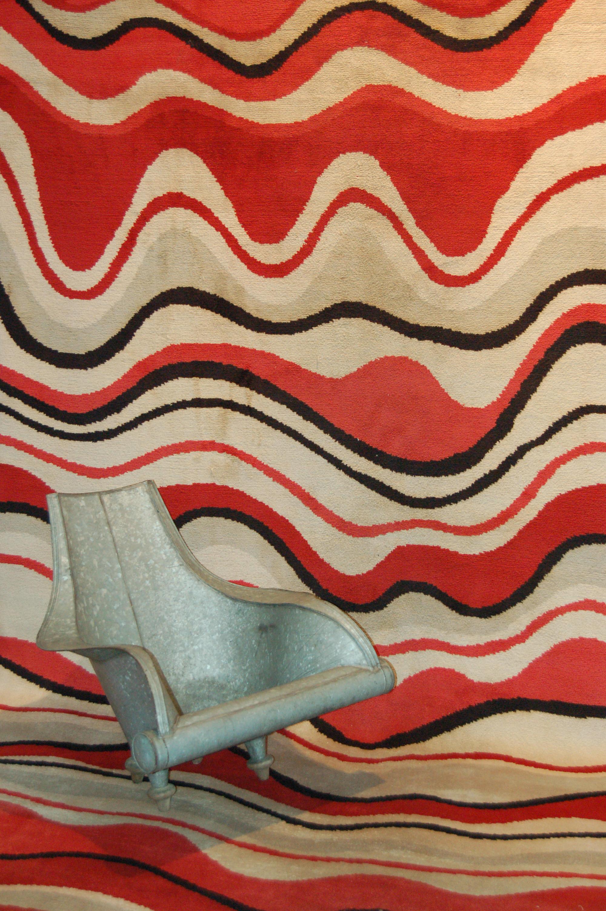 A stunning modernist carpet with an allover pattern composed of irregular waves in various shades of red, light grey and black on an ivory background. The 1950s were a very creative period for France, both in fashion as well as in design, the two