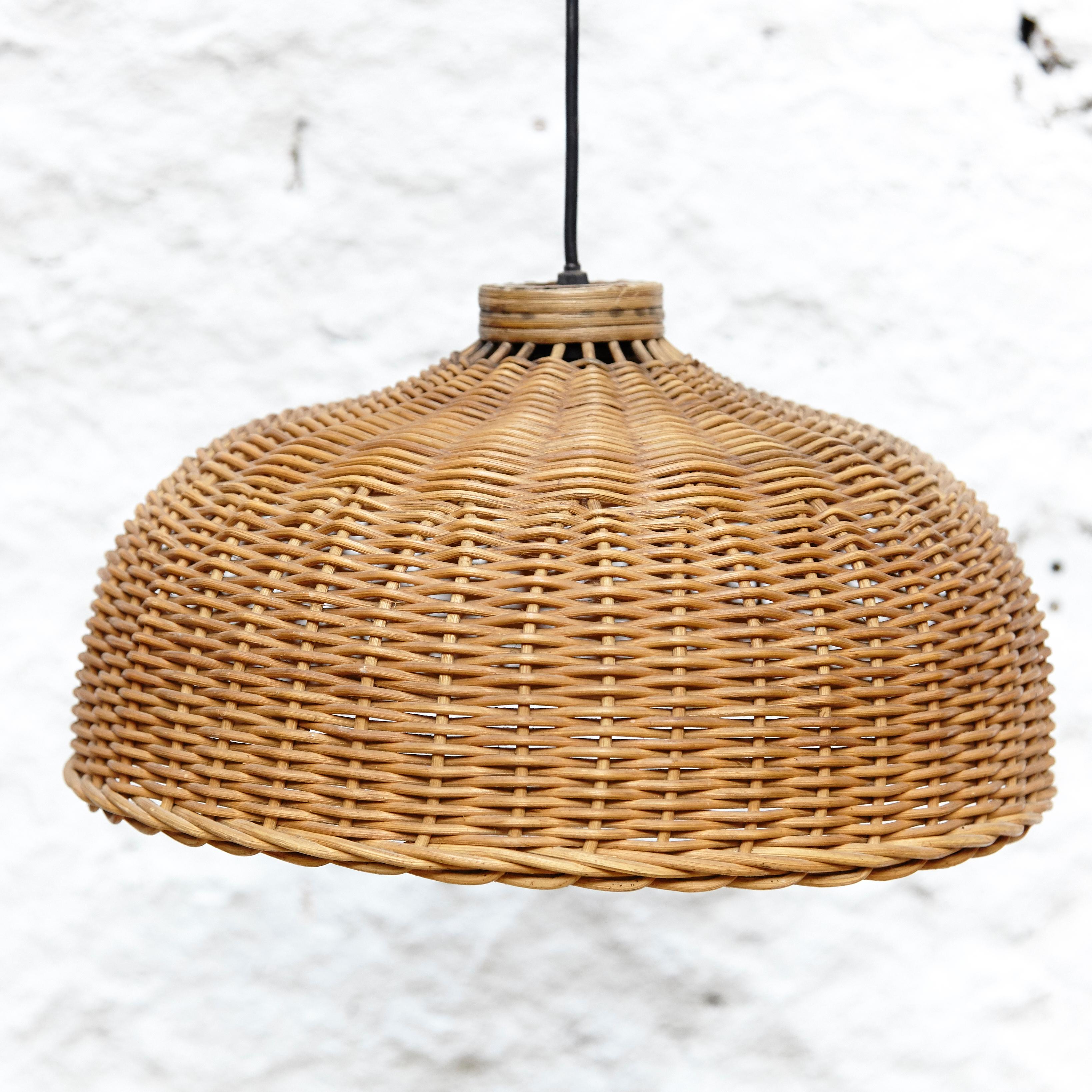 Rattan ceiling lamp by unknown designer.
Manufactured in France, circa 1960.

In original condition with in or wear consistent of age and use, preserving a beautiful patina.

 