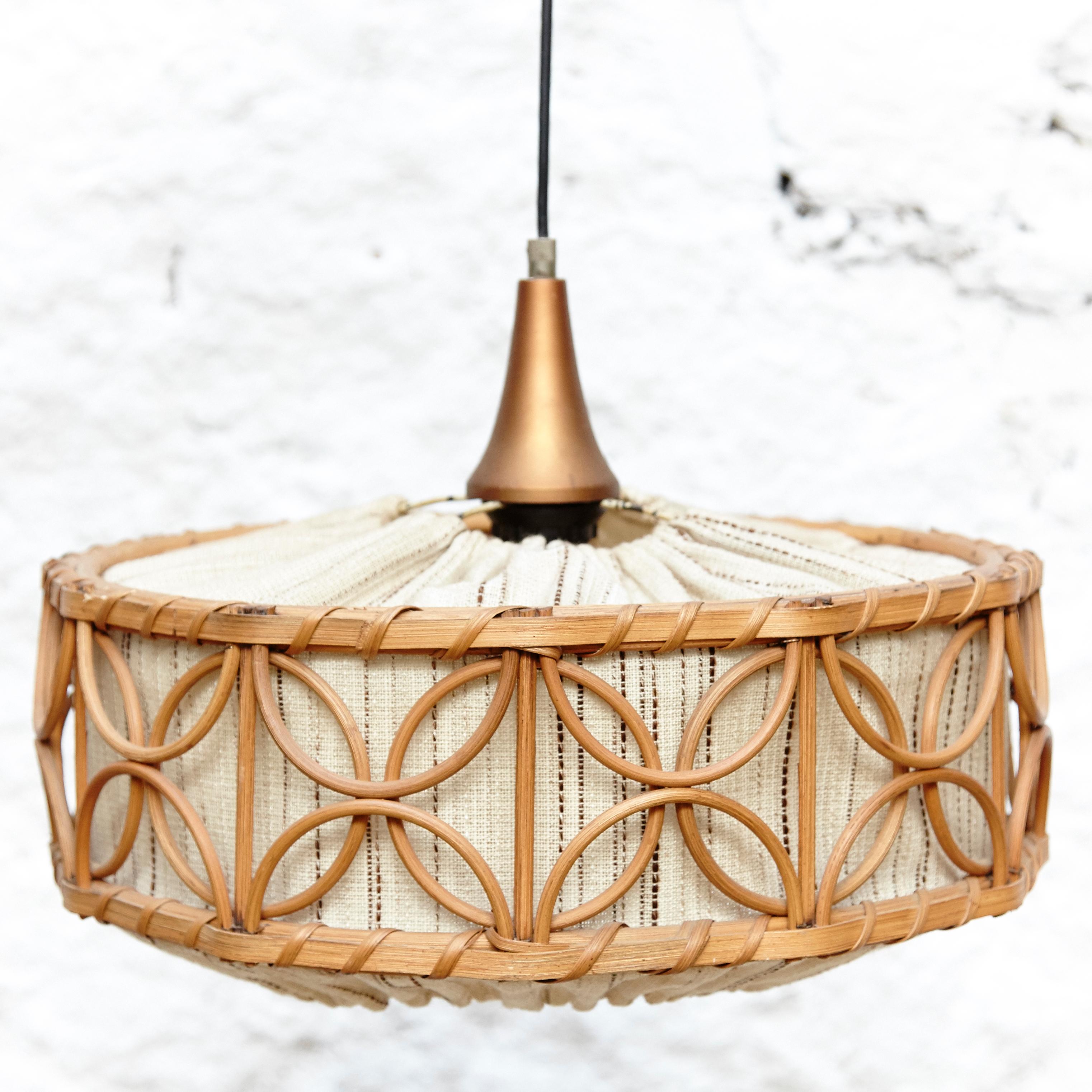Rattan and fabric ceiling lamp by unknown designer.
Manufactured in France, circa 1960.

In original condition with in or wear consistent of age and use, preserving a beautiful patina.