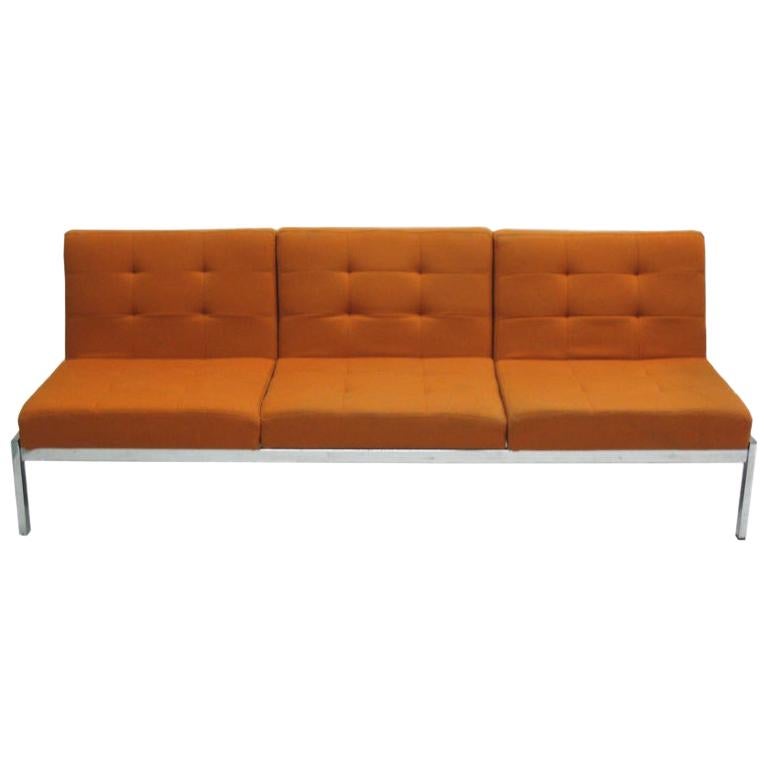 Sober French Mid-Century Modern sofa / couch / canapé by Airborne International with chromed metal frame and three seats in wool. 

There is a matching Airborne cocktail table and an end table that are also available from us. See 1st Dibs