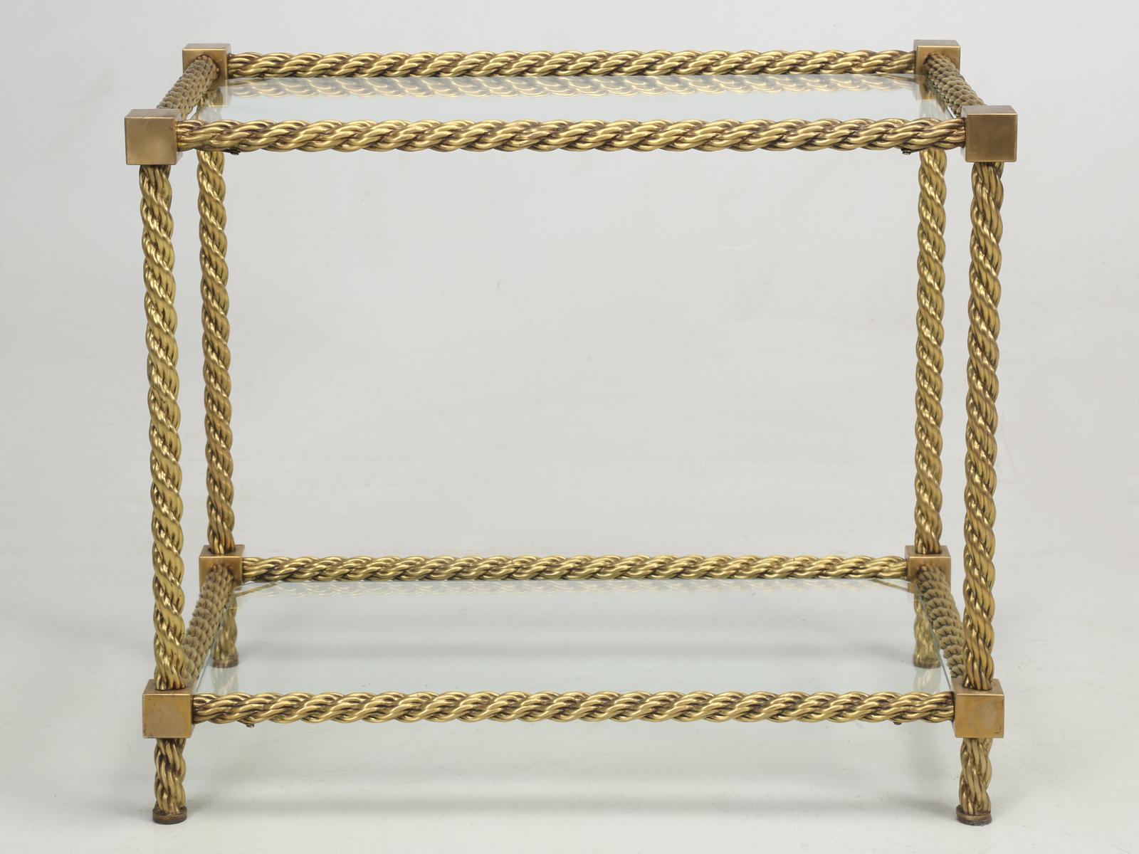 French Mid-Century Modern, twisted brass rope end table and I cannot say, that I have ever seen another one. Beautifully made and extremely heavy and we believe that the twisted brass French end or side table, probably dates from the 1960s. Light