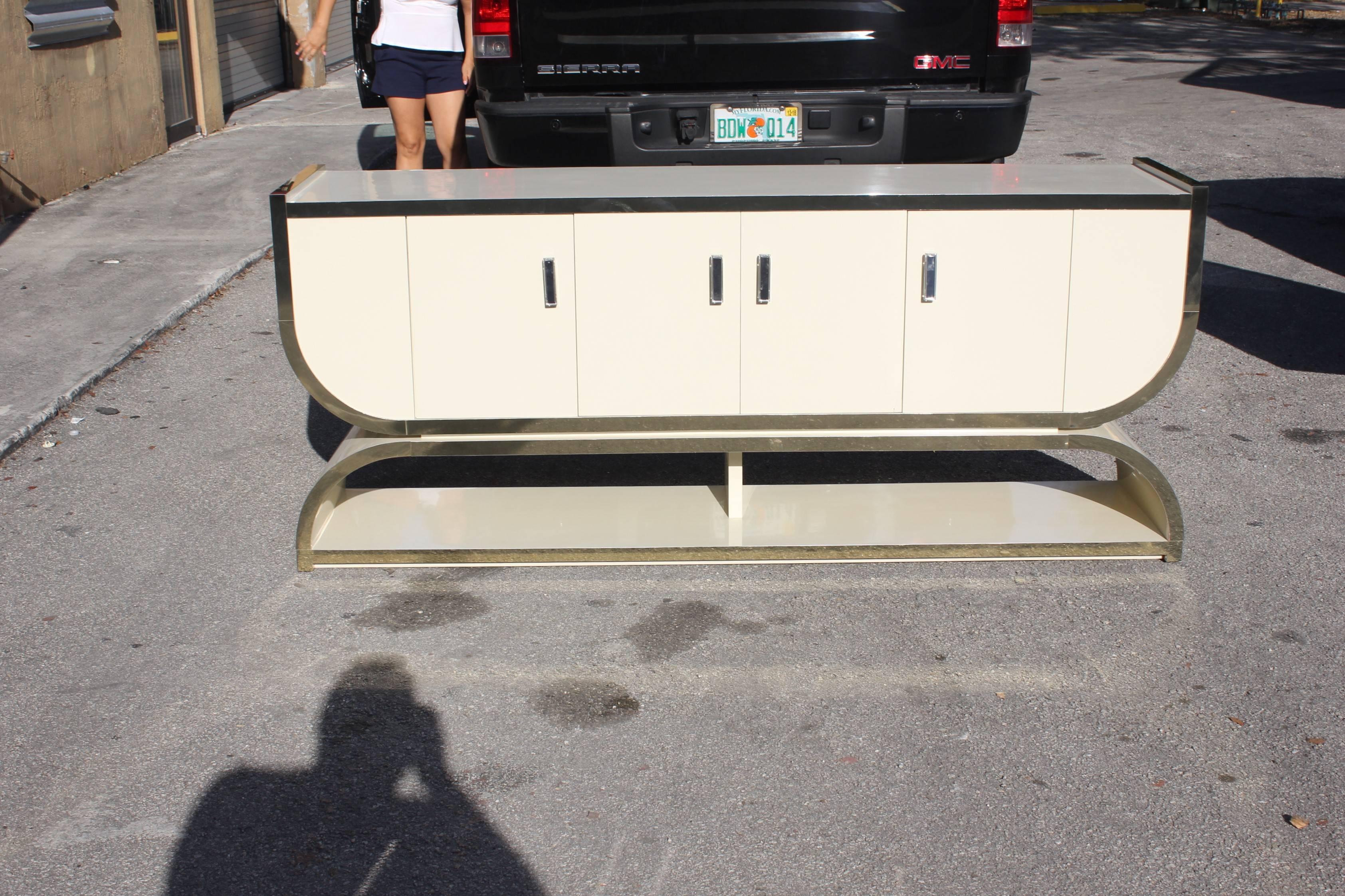 Beautiful French midcentury ''U'' shape sideboard or buffet, circa 1960s, four-door with hardware Lucite and beautiful brass detail, please note these buffets can be taken apart to accommodate elevator needs if necessary, We traveled to buy all our