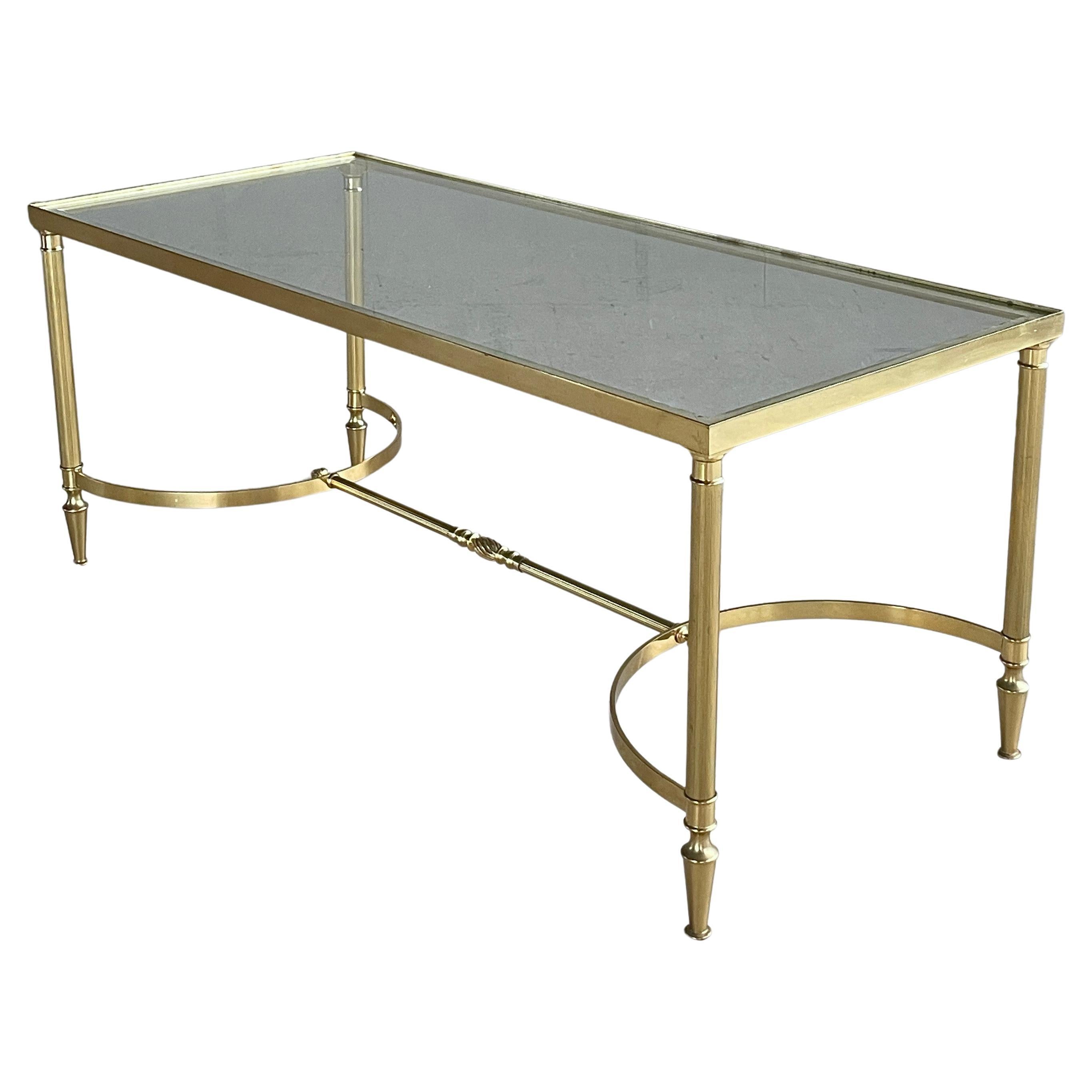 French Mid Century Neoclassical / Hollywood Regency Style brass coffee table / couch table with glass tabletop on a solid brass base. Nice detailing to base.
Designer: Unknown (In the Regency Style)
Producer: Unknown (France ca. 1950 -