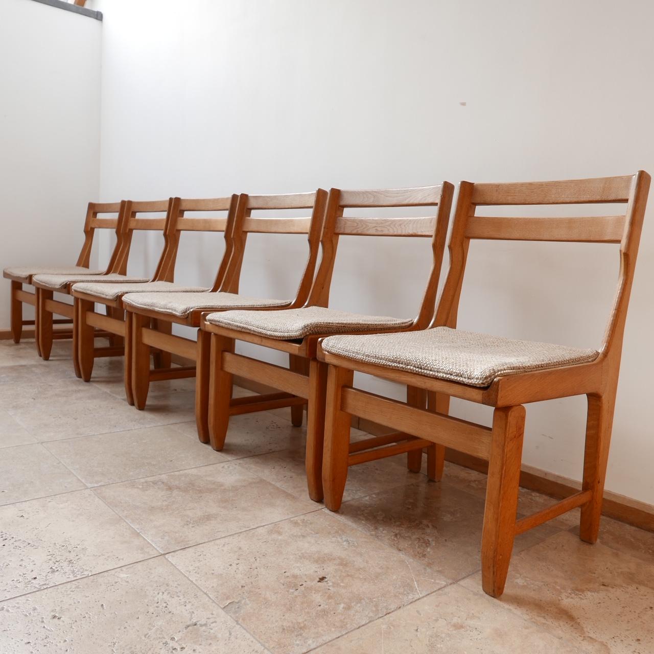 A good run of six oak dining chairs by French design legends Guillerme et Chambron,

France, c1960s. 

Original upholstery remains but wants updating. 

Good condition, some scuffs and wear commensurate with age. 

Dimensions: 49 W x 48 D x