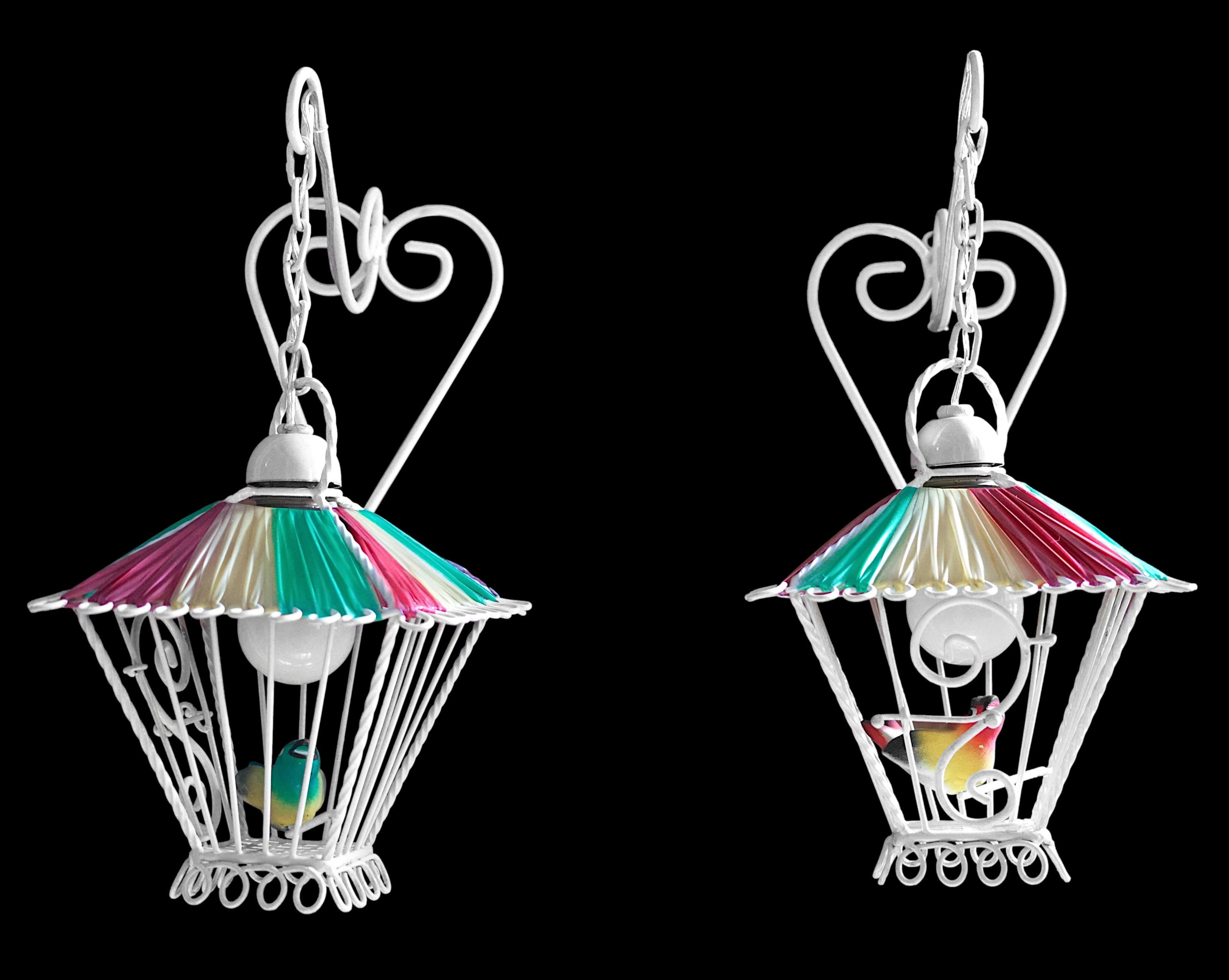Amazing pair of wall sconces in the shape of birdcages. Each iron cage has a movable door. The roof is made of synthetic fabric in the colors typical of this period in France. Inside, an enamelled terracotta bird surely. The set is in very good