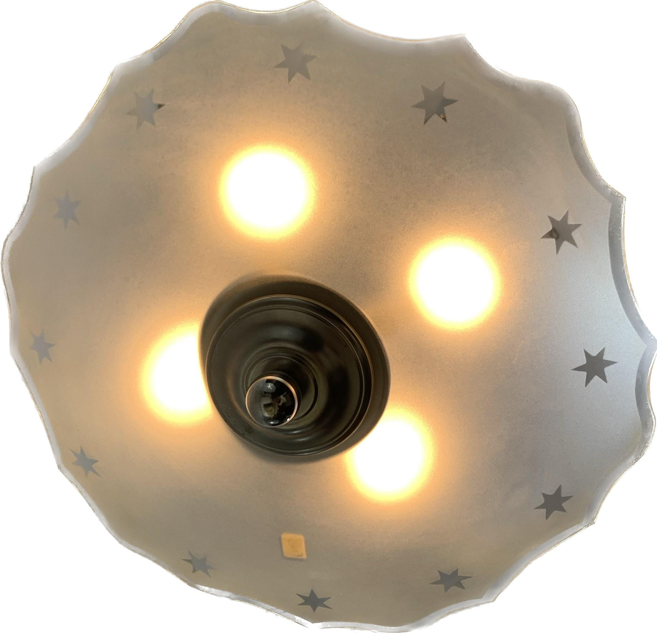 French Art Deco modernist pendant light. White glass shade in semi curved lines around the edge decorated with stars.