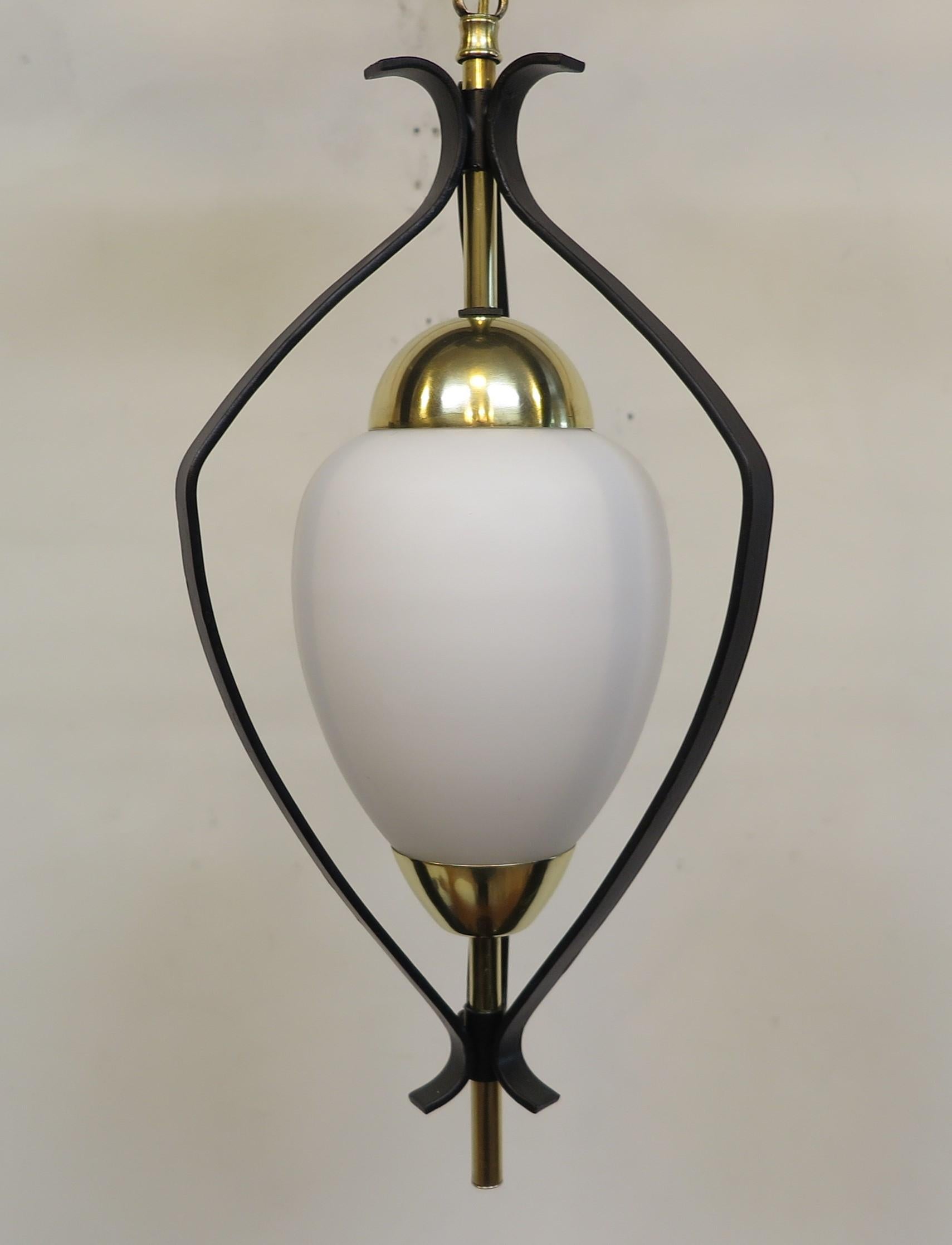 French mid-century pendent light by Maison Arlus. Mid-Century Modern French pendent lantern style hanging light. Frosted milk glass shade set in between brass caps on brass rods suspended in a modern lantern style Iron fixture. Hard to find these