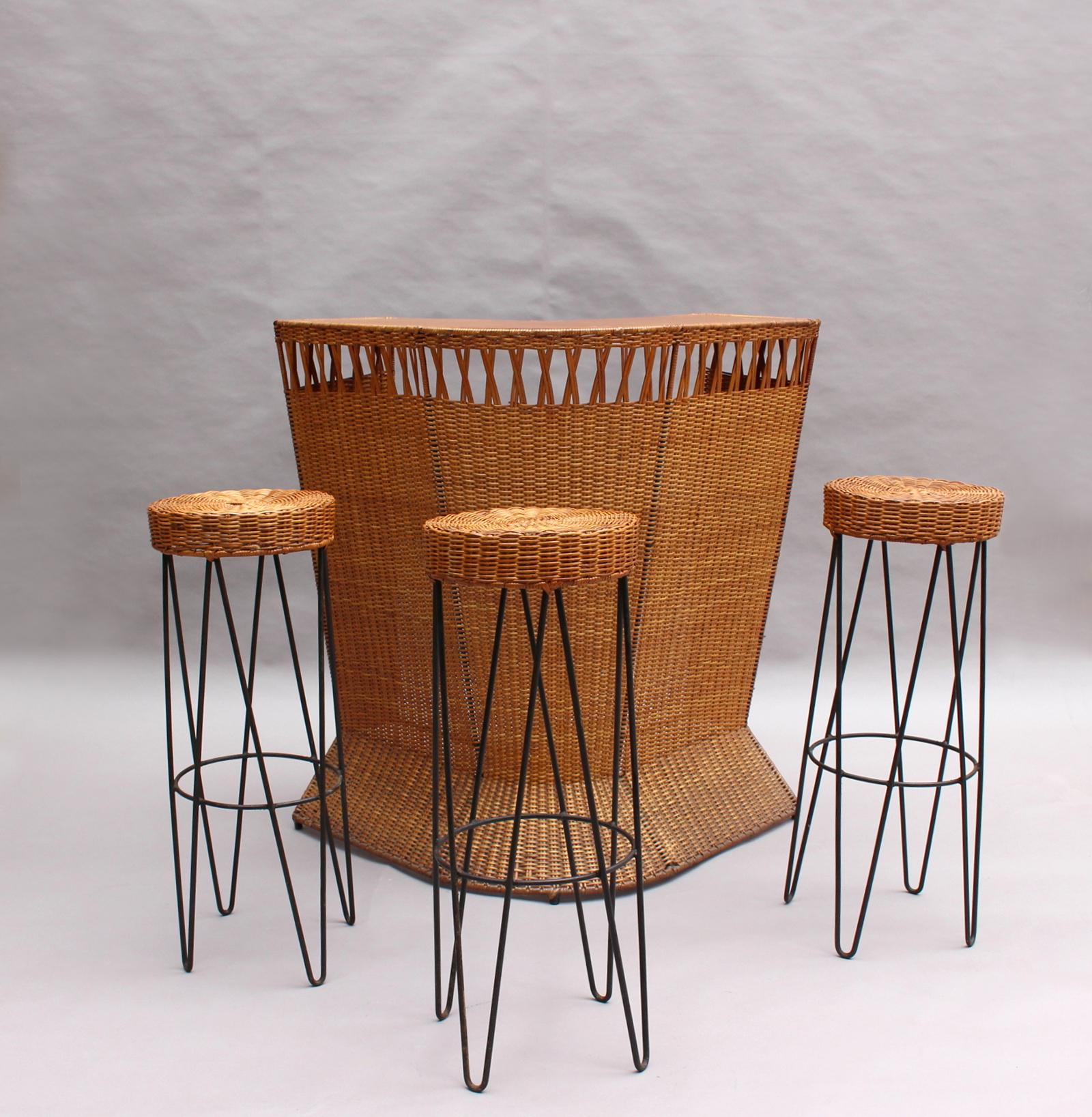 A French 1950s black metal-framed rattan bar with three matching wicker stools

3 additional stools are also available - 1stdibs ref # LU78488715193 - 

Stools dimensions are :
Height: 31.5 in. (80 cm)
Diameter: 13 in. (33 cm).
 