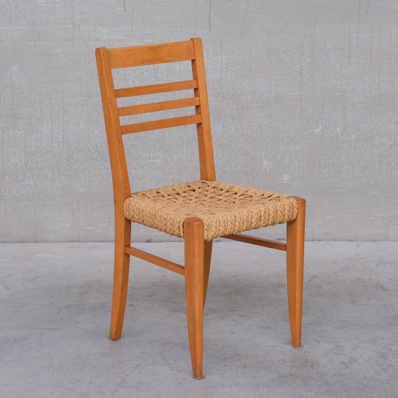 A set of five dining chairs. 

Attributed to Audoux-Minet. 

France, c1960s. 

Rope work seats on a wooden frame. 

Price is for the set. 

Some scuffs and wear commensurate with age. 

Location: Belgium Gallery. 

Dimensions: 87 H x