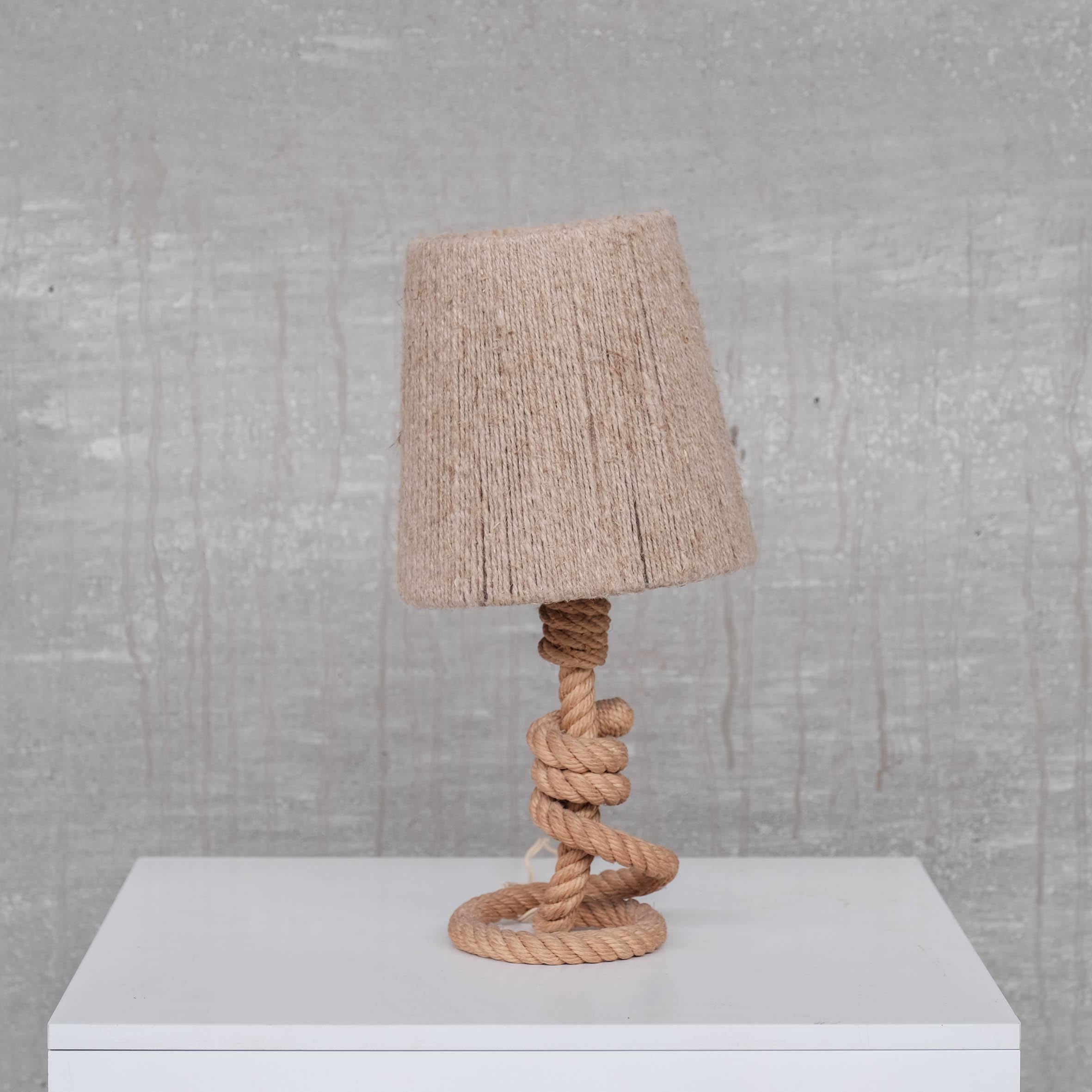 A petite rope table lamp. 

France, c1960s. 

Attributed to Audoux-Minet. 

With matching rope cord shade. 

Since re-wired and PAT tested. 

Good vintage condition. Some scuffs commensurate with age. 

Location: Belgium Gallery. 

Dimensions: 31 H
