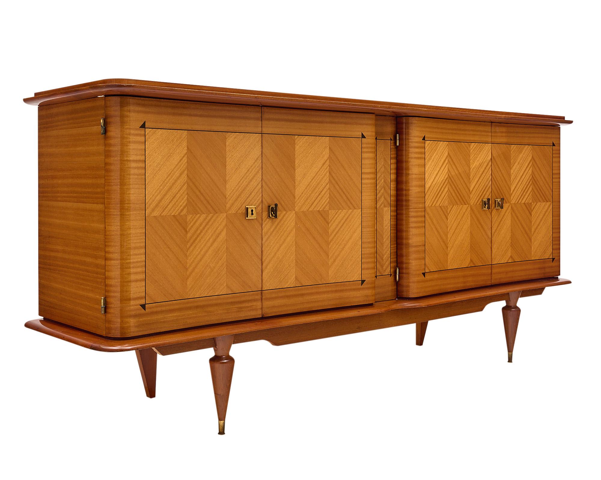 Buffet from France made with an impressive rosewood parquetry façade. The piece features four doors with working locks and keys that open to interior shelving. The high-shine finish and lovely curved lines give this buffet a beautiful decorative