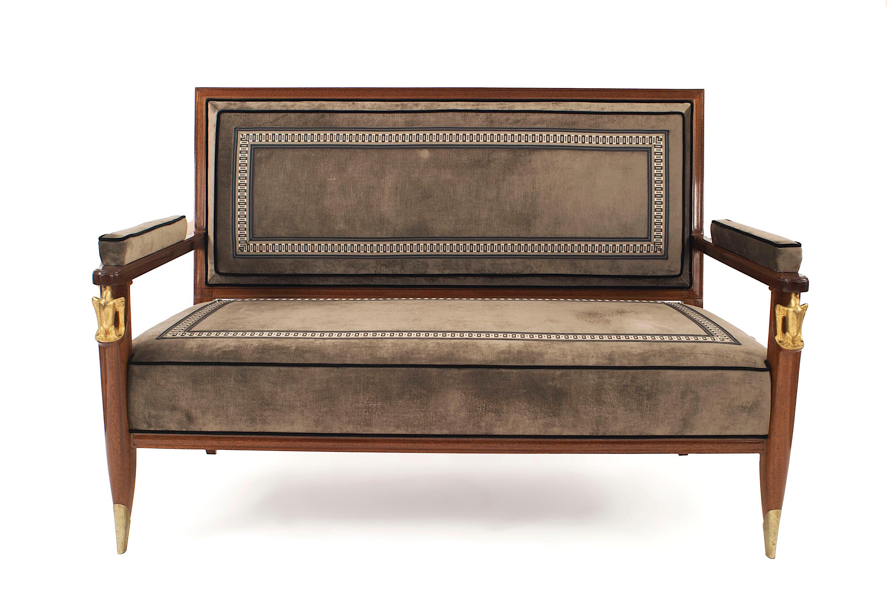 French mid-century dark mahogany settee with gilt bronze sabot feet and armrest supported by gilt bronze eagles with brown upholstery. Signed Jean Pascaud, by Vadim Androusov (ref: Les Decorateurs des annee 40, pg 172).


Jean Pascaud was born in
