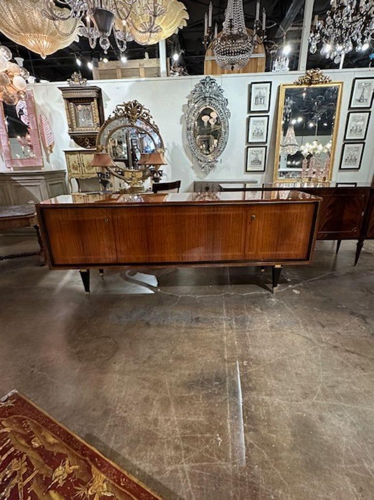 Outstanding French Mid-century mahogany and ebony sideboard with brass trim. Circa 1940. A timeless and classic touch for a fine interior.