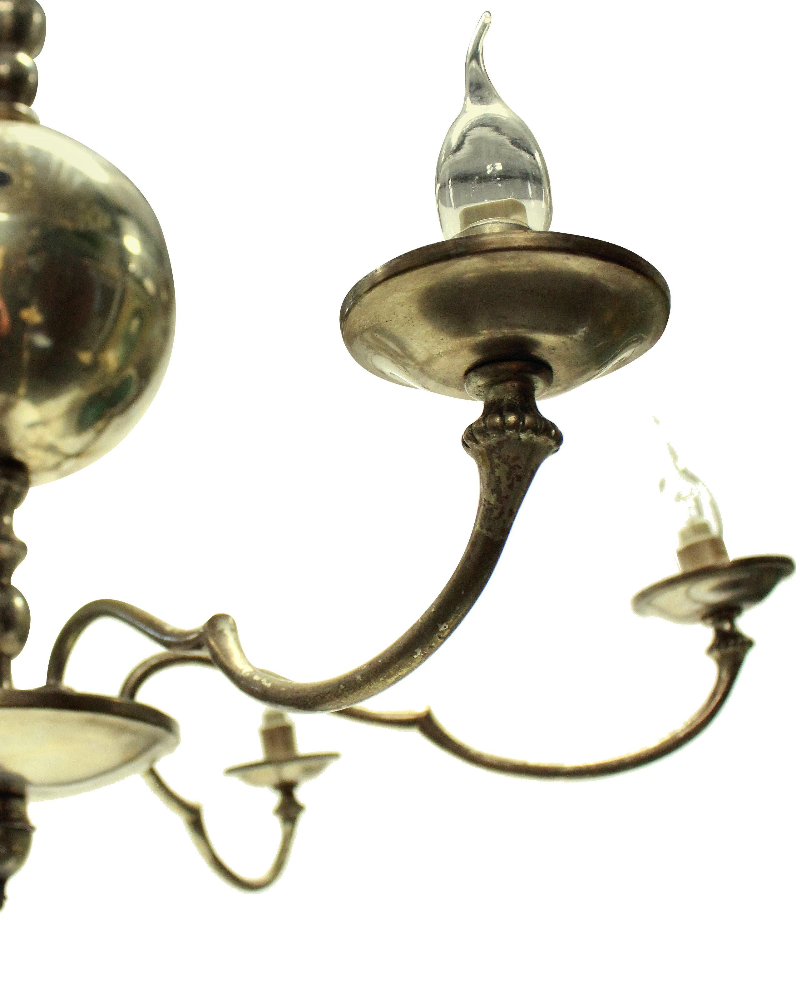 A French mid-century silver plated chandelier comprising six arms with a spherical central stem.