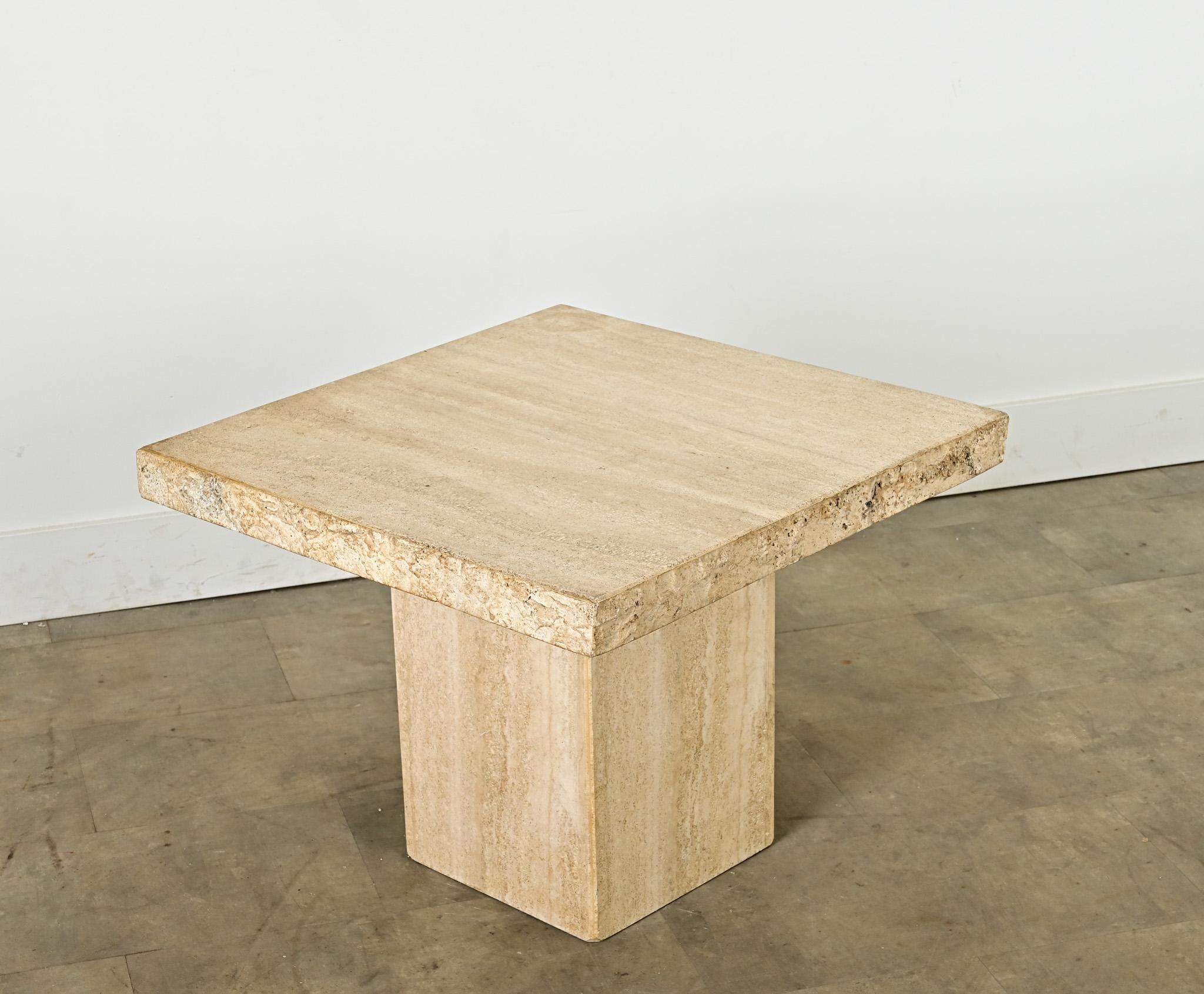 This circa 1970 French travertine square end/side table has a clean and modern look yet one that is warm and approachable for all of your entertaining needs. The raw edges of the beige stone top have a tactile, ancient quality in contrast to the