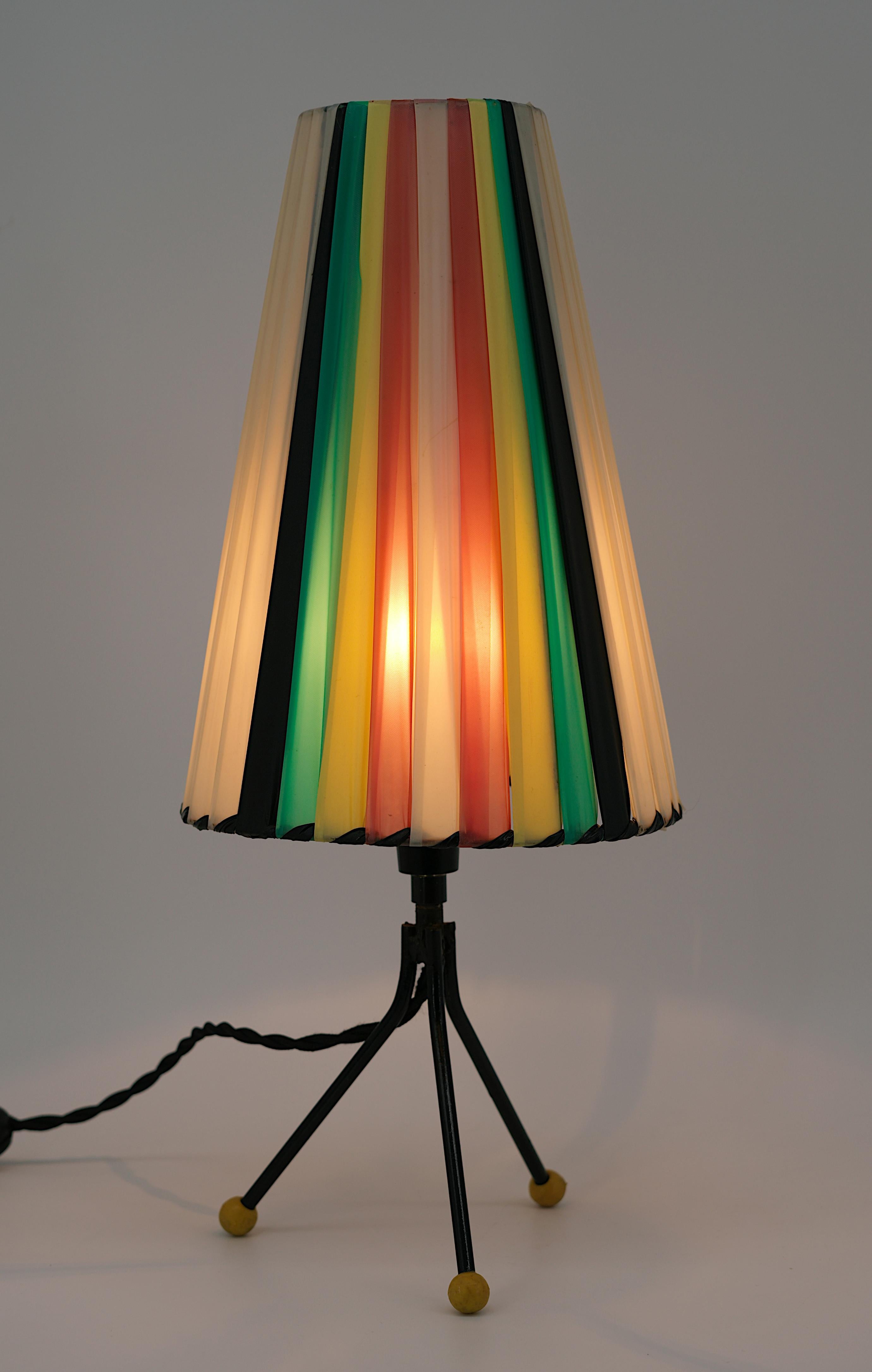 Midcentury table lamp, France, 1950s. Table lamp featuring a synthetic fabric slatted shade on a metal tripod base with rubber balls. Height : 41cm -  13.2 inches, Diameter : 18cm - 7.1 inches. Some slight traces of age on the lampshade. Delivered