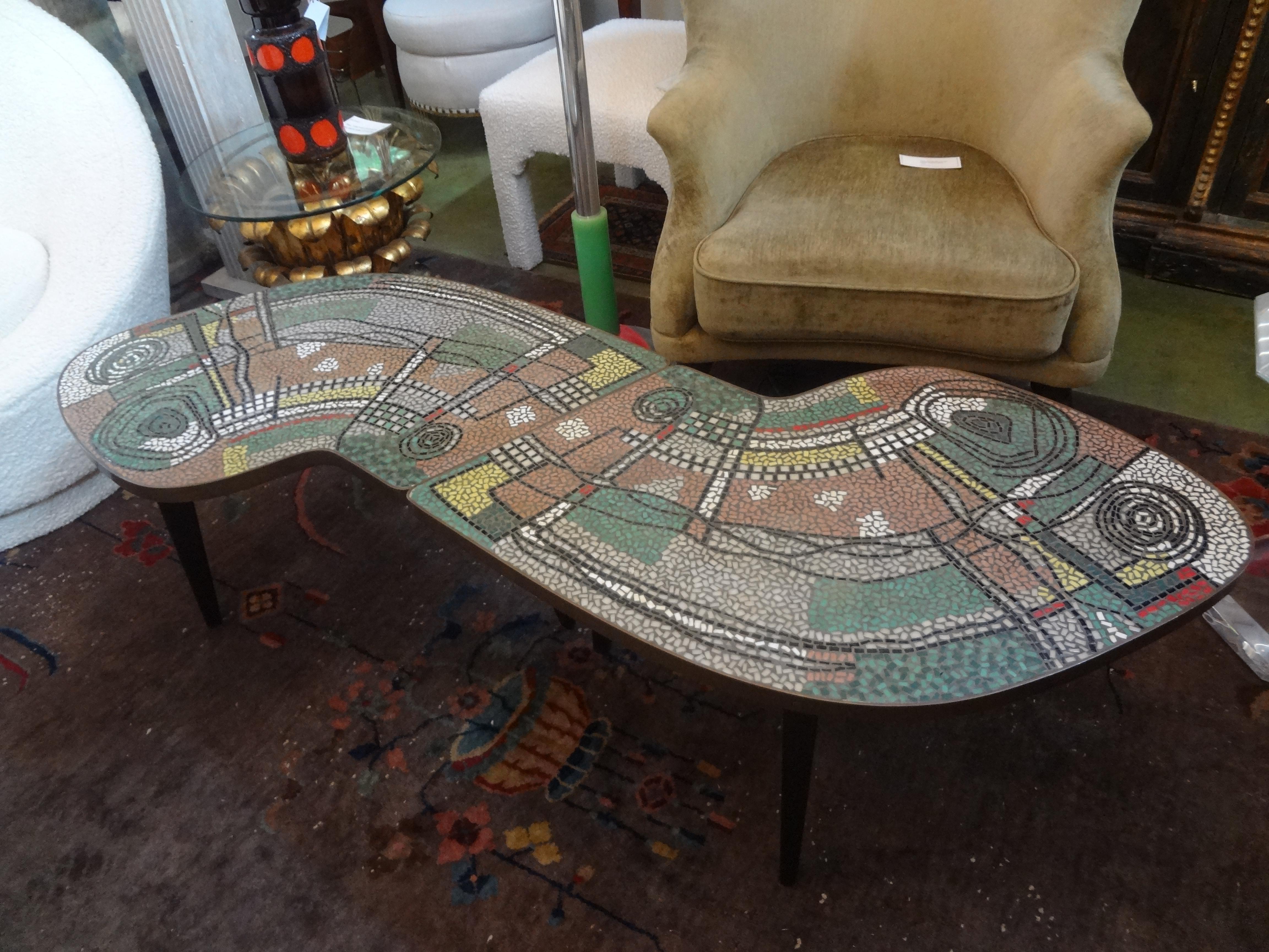 Rare stunning French Mid-Century Modern two part mosaic tile topped curved table. These fantastic French curved tables can be used together to create a large cocktail table or separated and used as a pair of curved side tables. This pair of tables