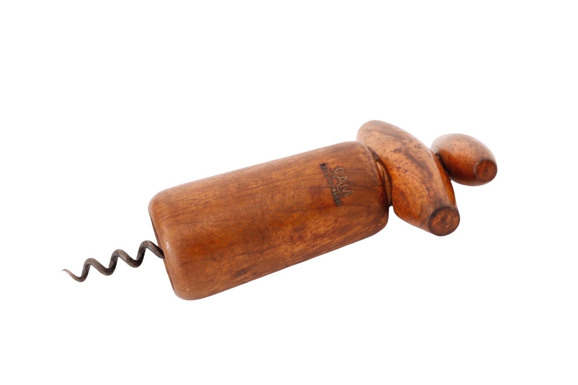 A French mid century waiter’s corkscrew in maple, made by CAM. The double handle design allows you to remove the cork by turning first the top handle then both together in the same direction. Handles are inlaid with blonde maple at each side. Marked
