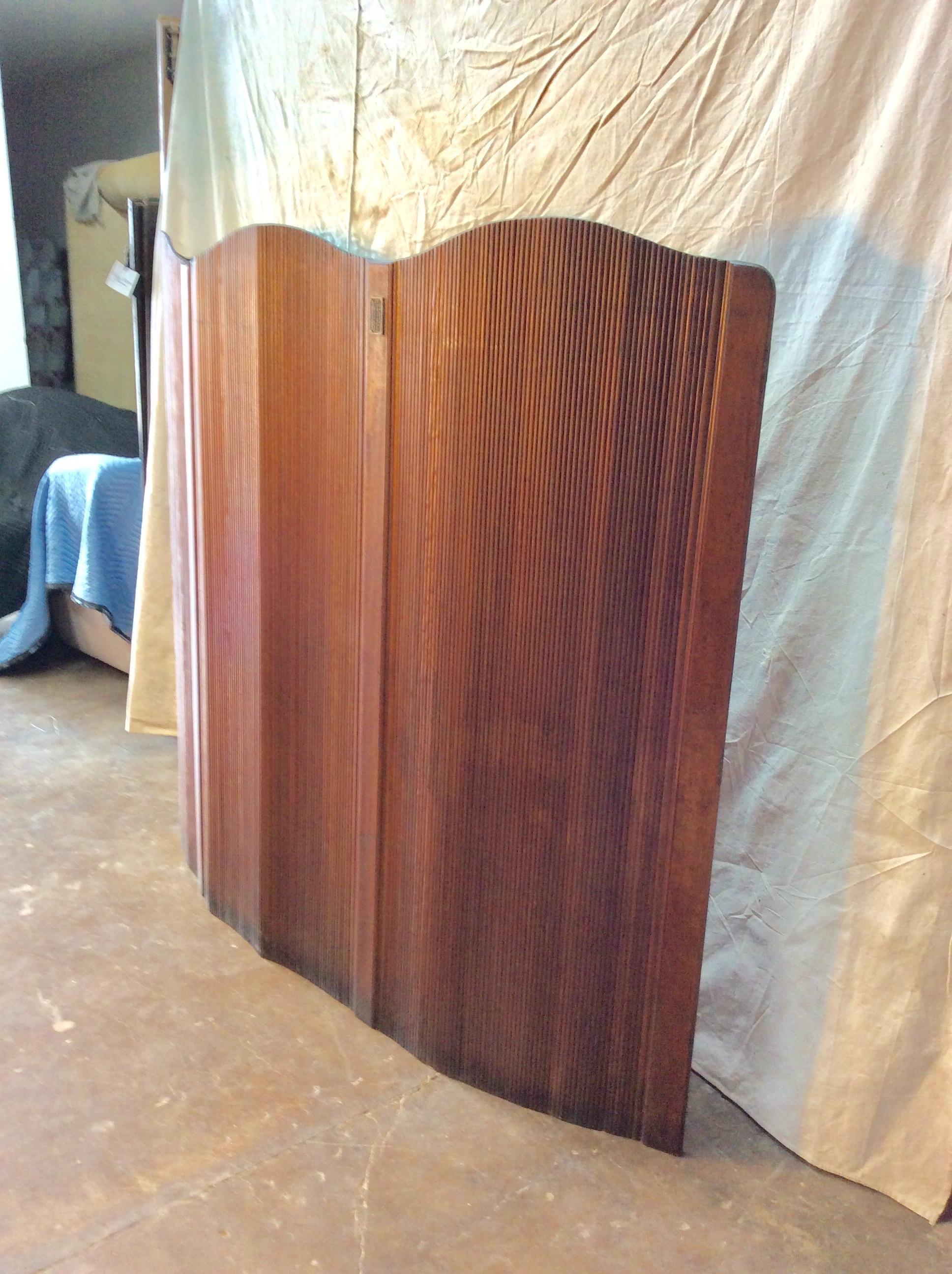 Found in France, this French Art Deco freestanding room divider / folding screen in patinated pine was made by A. Poirel & Ch. Pignolet of Nancy, France. This flexible paravent is made out of strips of wood allowing the screen to stand freely,