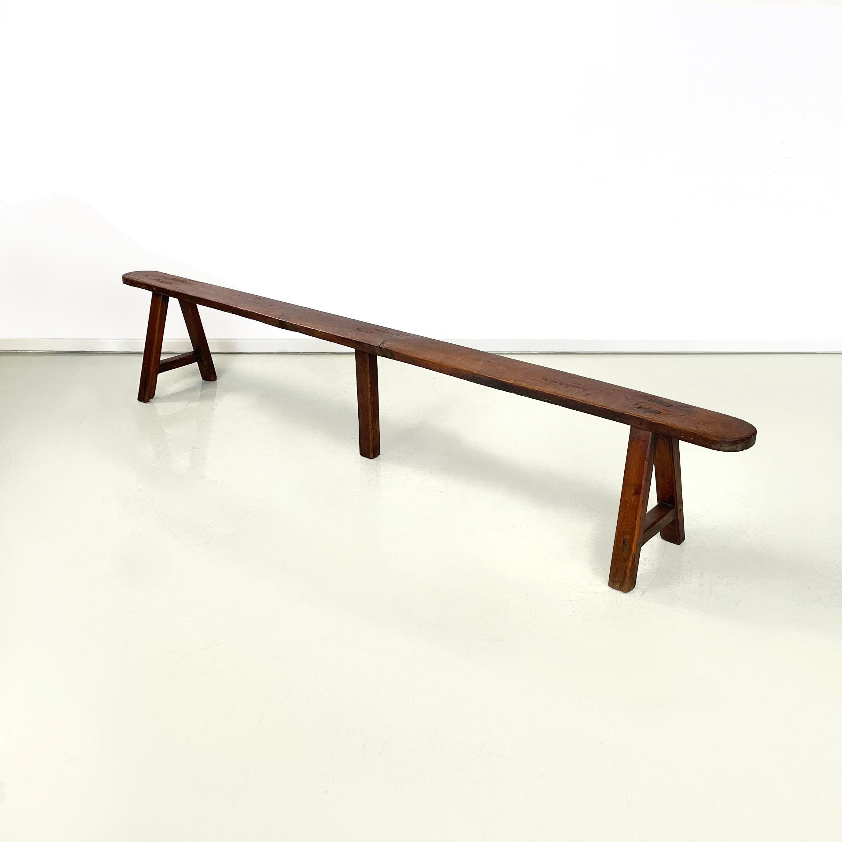 French mid-century Wooden benches with narrow and long seat, 1930s
Pair of benches with narrow and long seat with rounded corners, entirely in solid wood. The legs with a square section facing outwards are positioned diagonally joined by a strip,