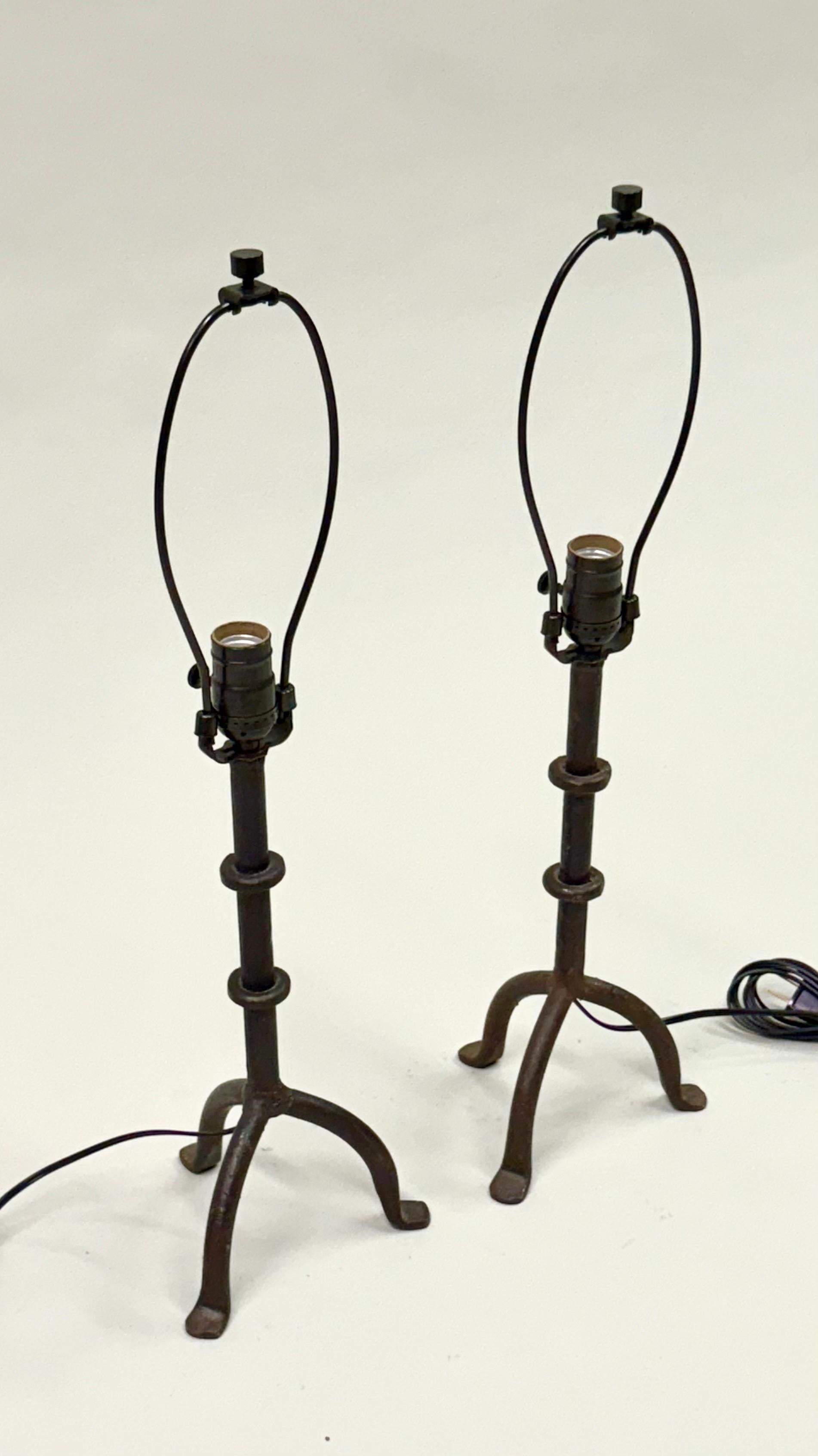 An Elegant and Timeless Pair of French Mid-Century Modern Hammered Wrought Iron Table Lamps in the Style of Alberto and Diego Giacometti, France, circa 1930 - 1950. The works are striking in their purity and direct, natural quality for which the