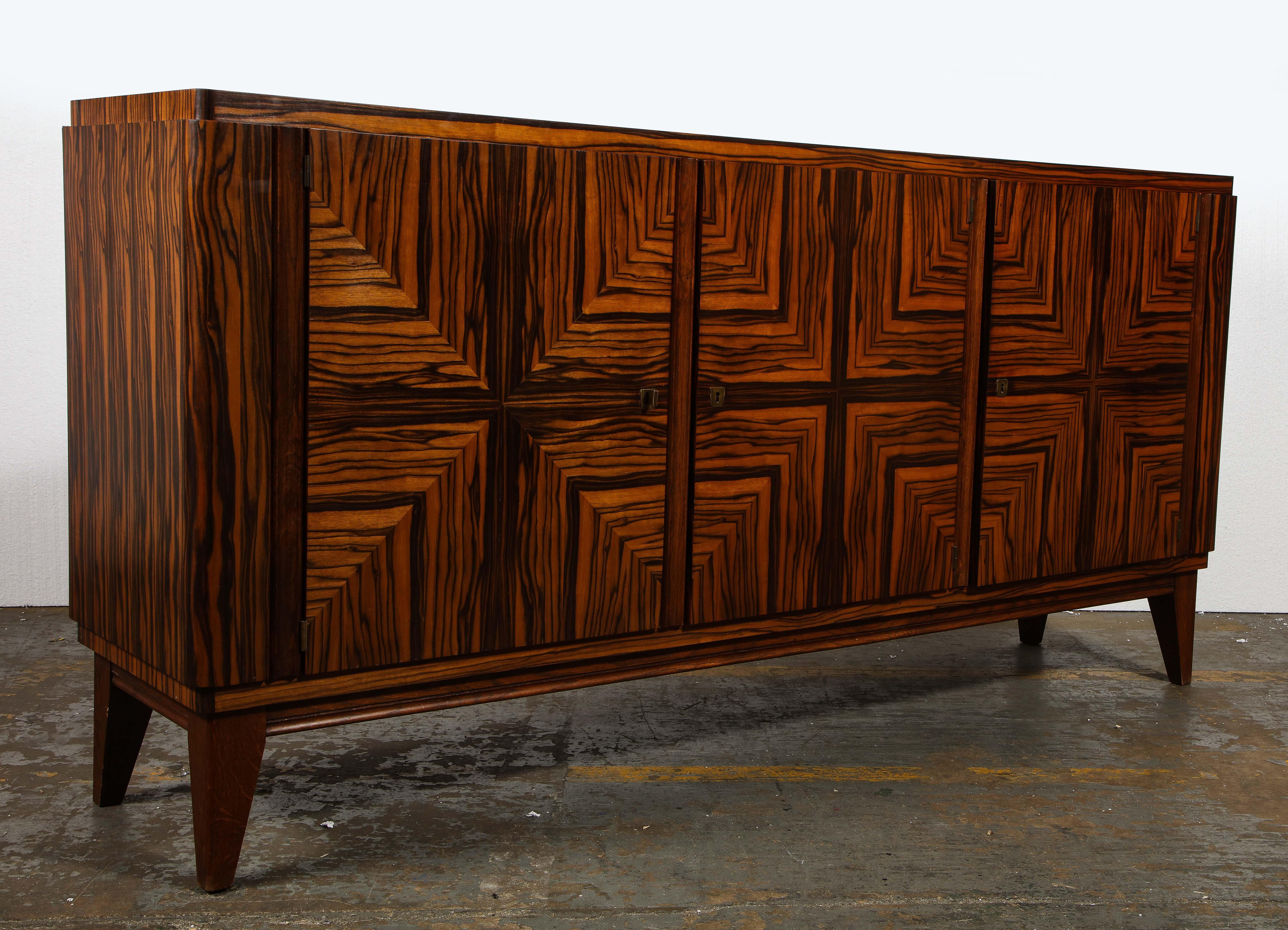 French midcentury zebra wood buffet sideboard, 1950s

Incredible geometric wood detailing throughout. French midcentury solid wood sideboard. 

Measures: 85 inches wide
20 inches deep
42 inches high.