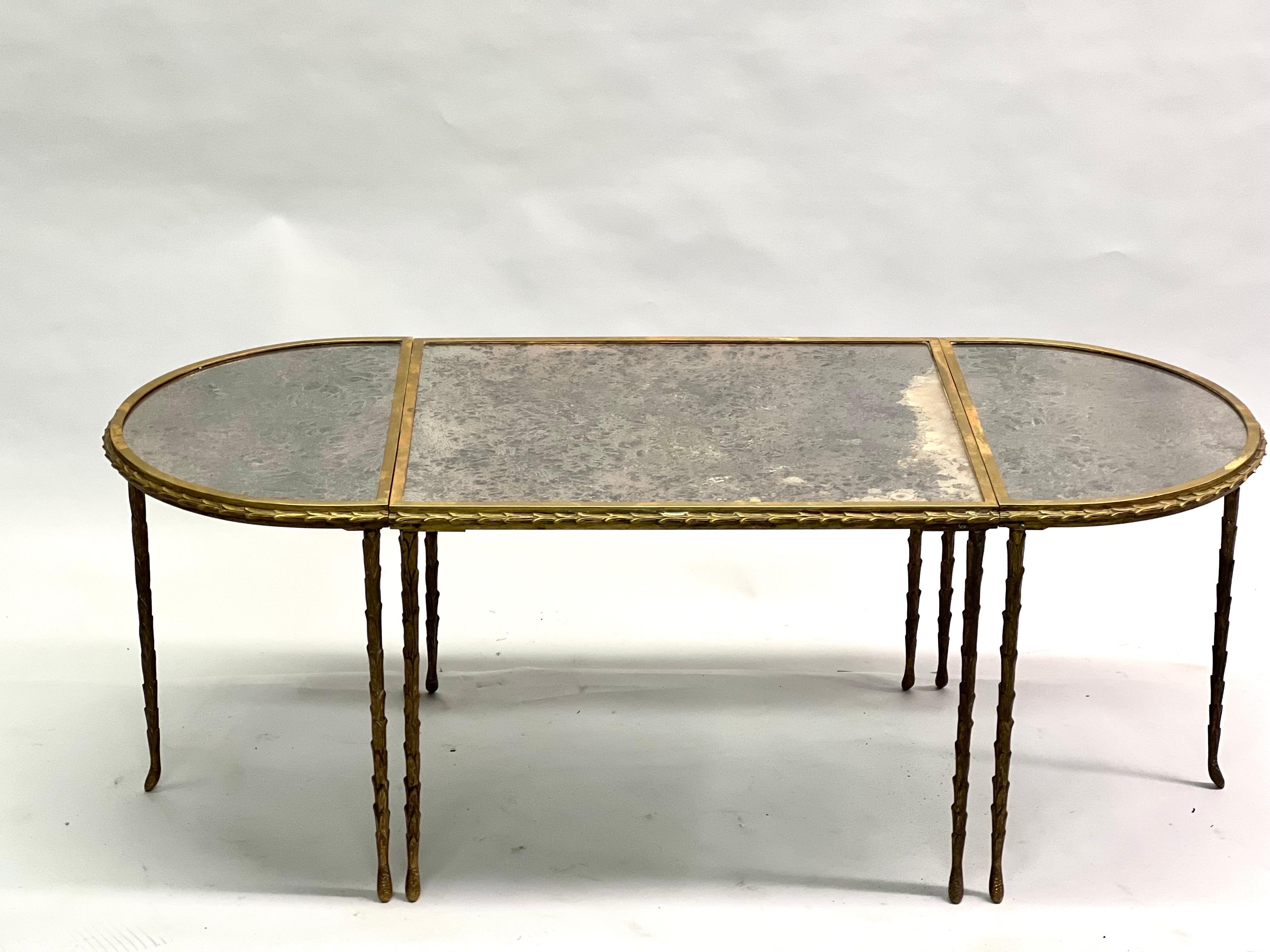 Elegant and Timeless French Mid-Century Modern neoclassical cocktail table by Maison Bagues in gilt solid bronze composed of one center table and two semi-circular end tables. The pieces are cast in bronze in the form of Palm Fronds and covered with