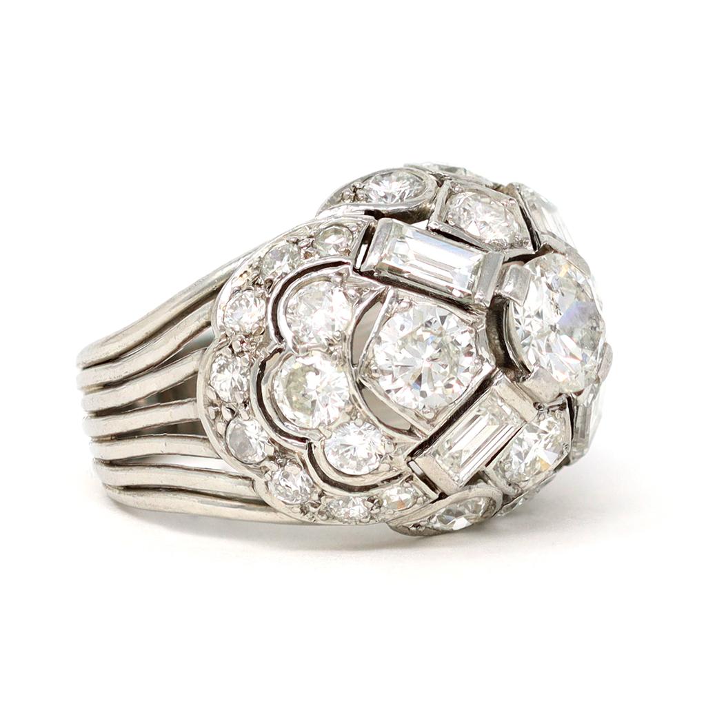 A French Diamond Dome ring in 18K white gold, circa 1950. Handmade in France during the mid-century period, this Dome ring features full cut and baguette Diamonds weighing a total of 3.80 carats and of GH color and VS-SI clarity. Set in 18K white